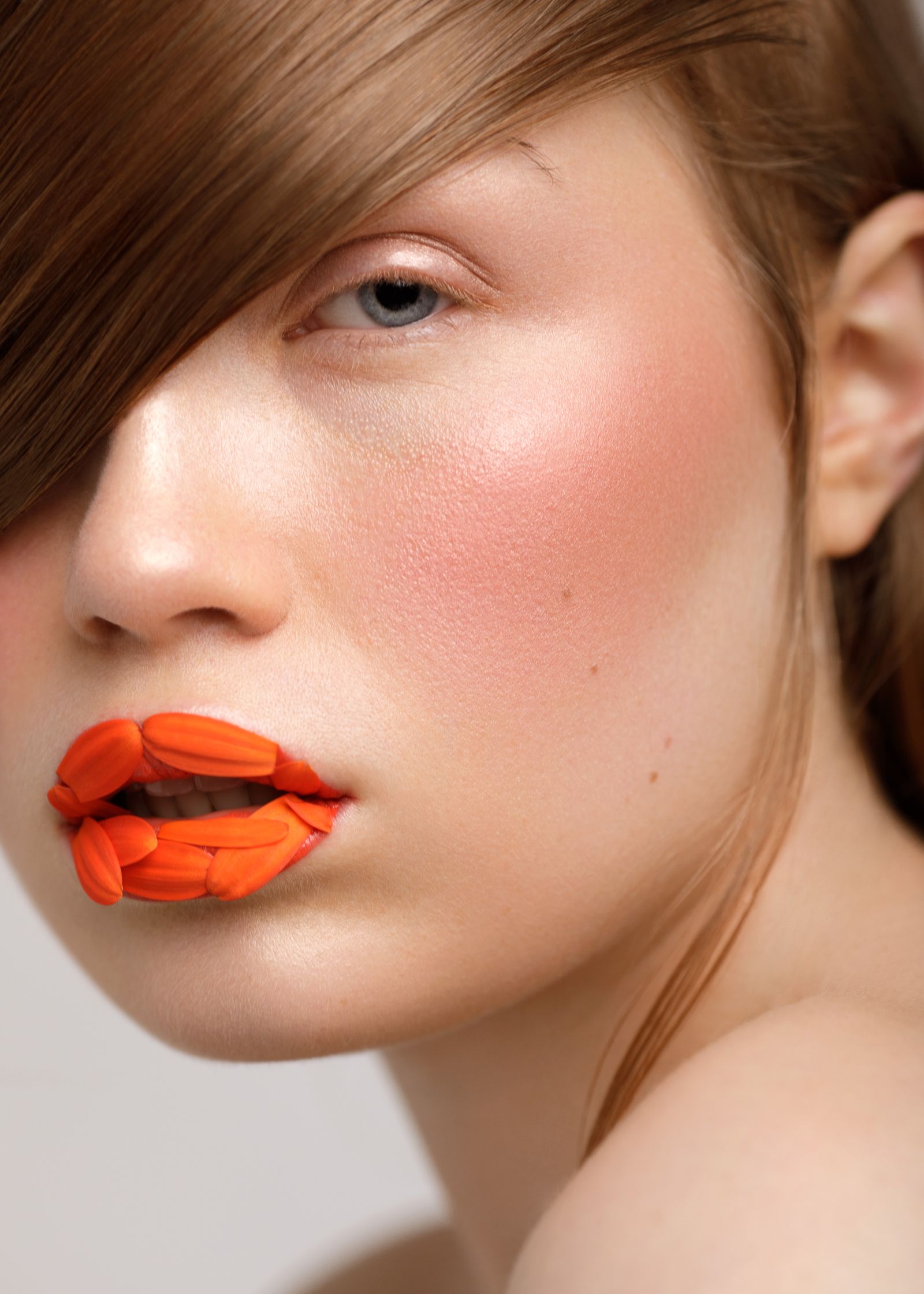 a woman with orange lipstick on her lips