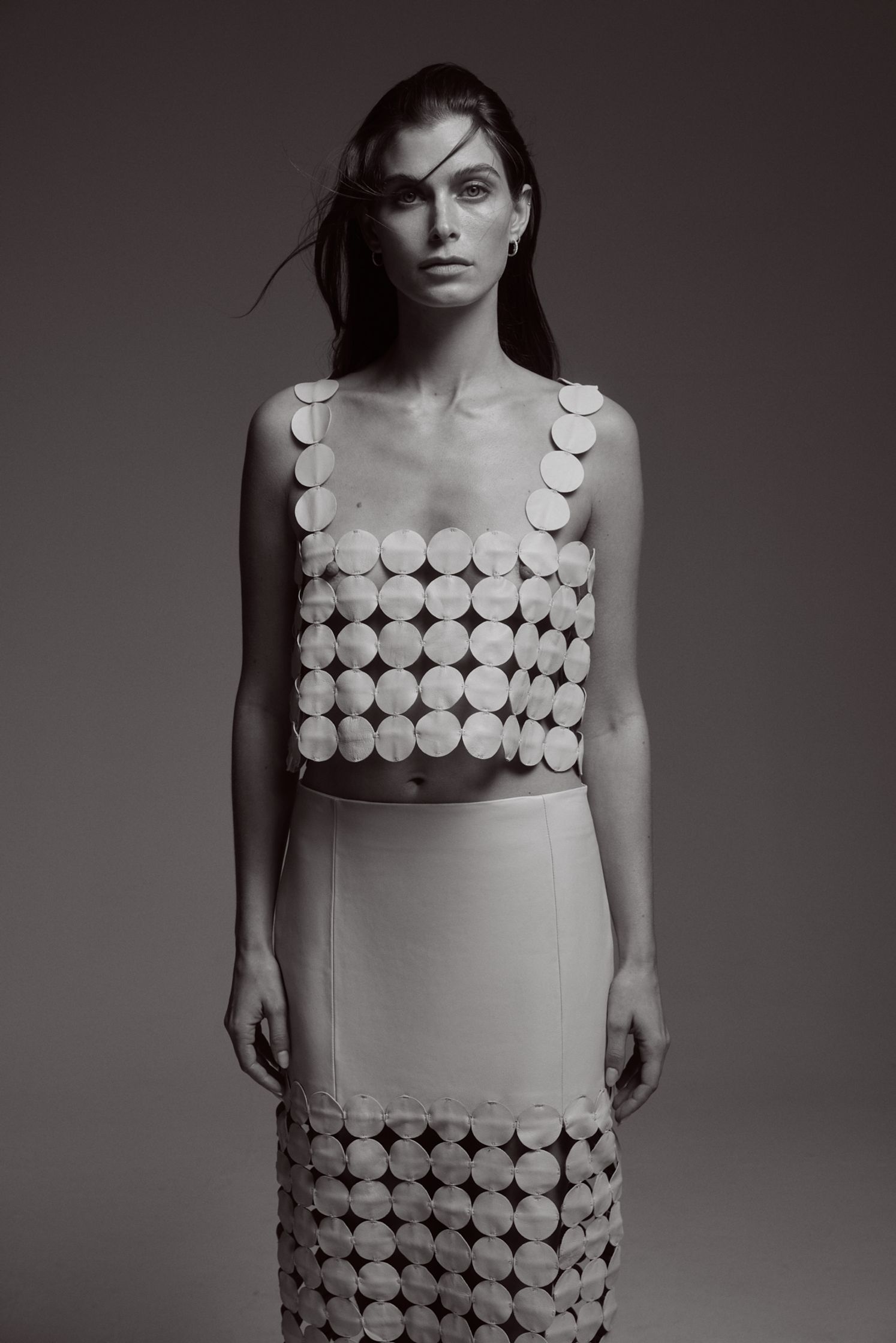 a woman is posing in a black and white photo