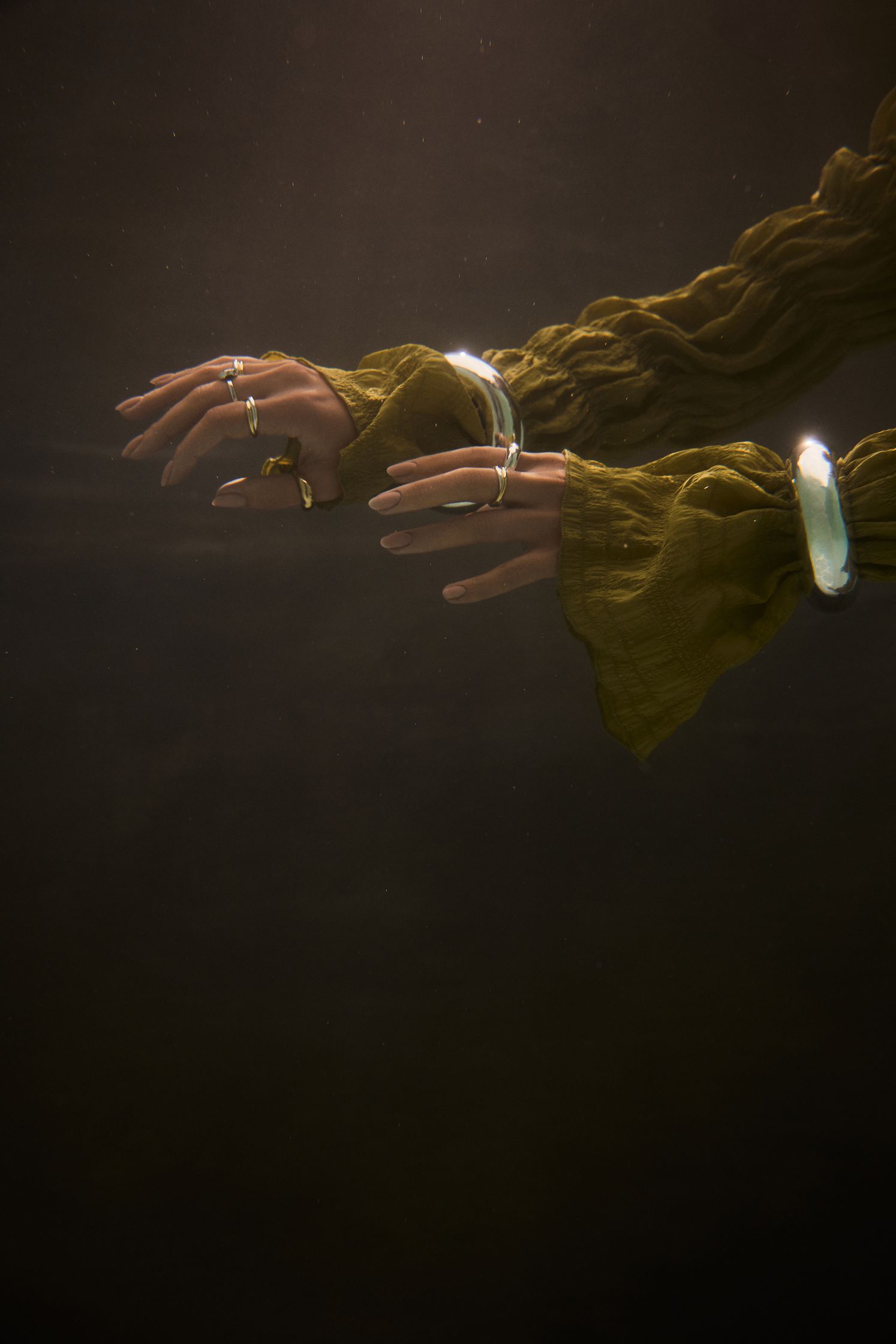 a woman's hands are floating in the water