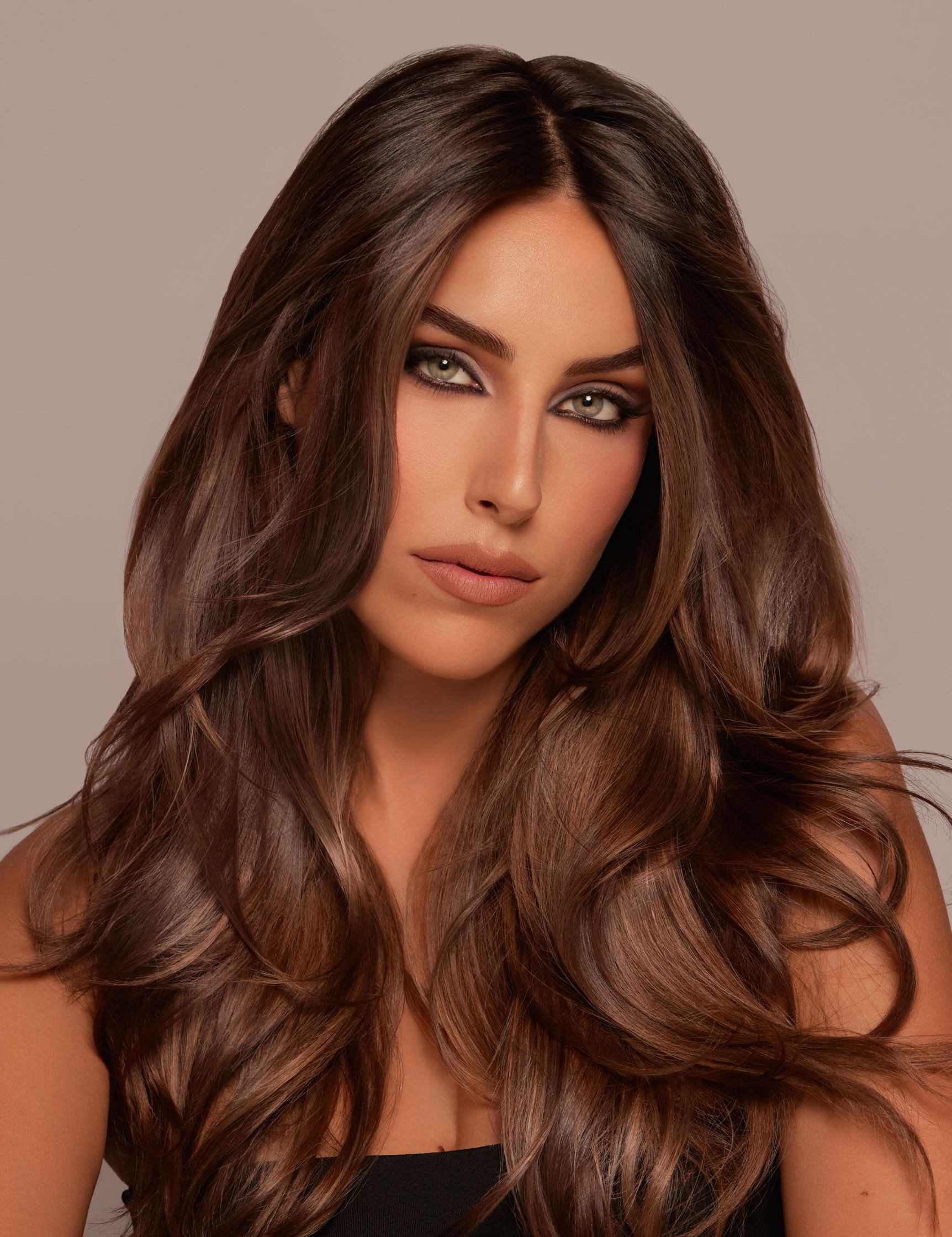 a woman with long brown hair is posing for a photo