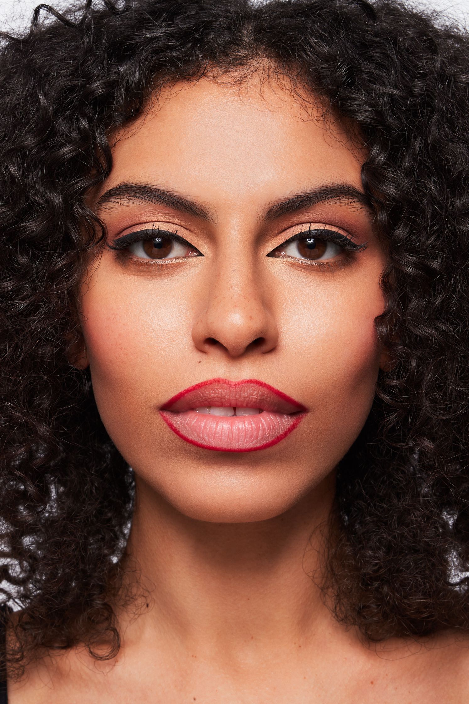 a woman with curly hair and red lipstick