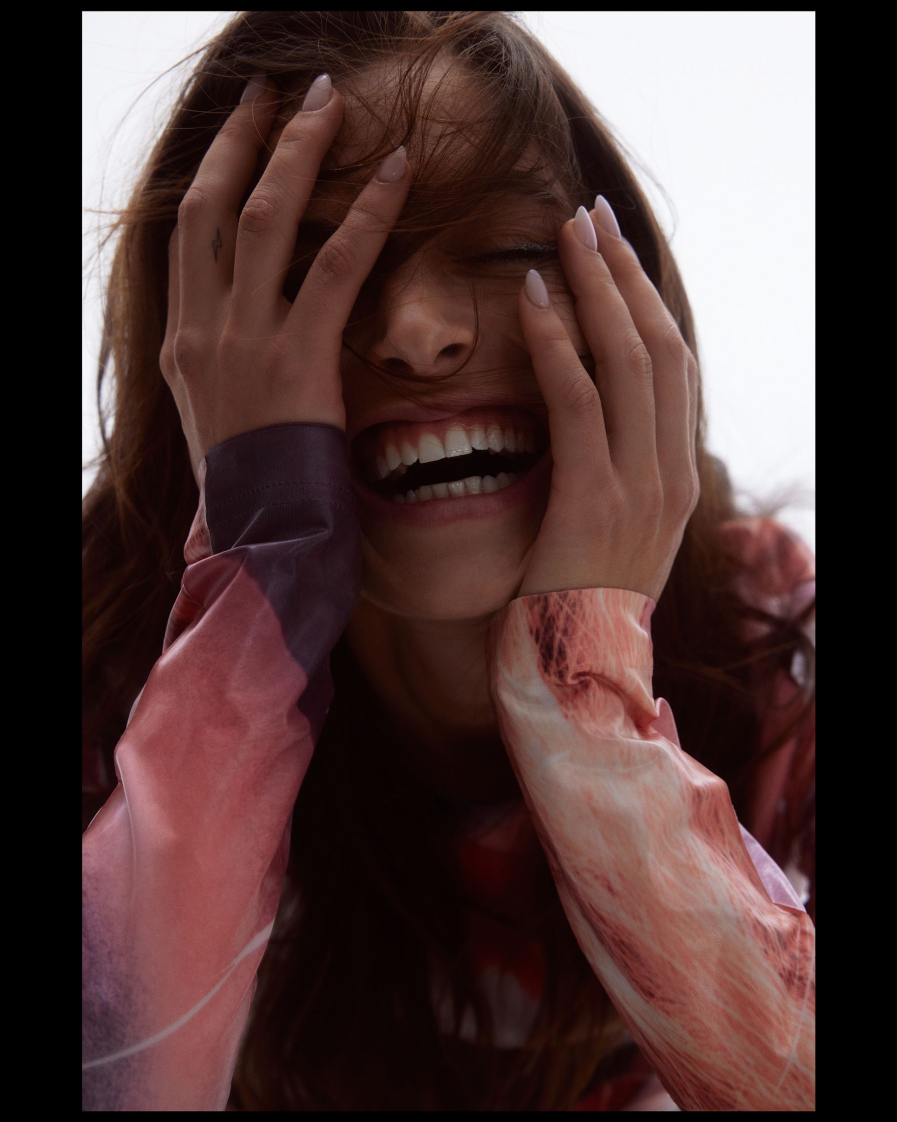 a woman with her hands covering her face