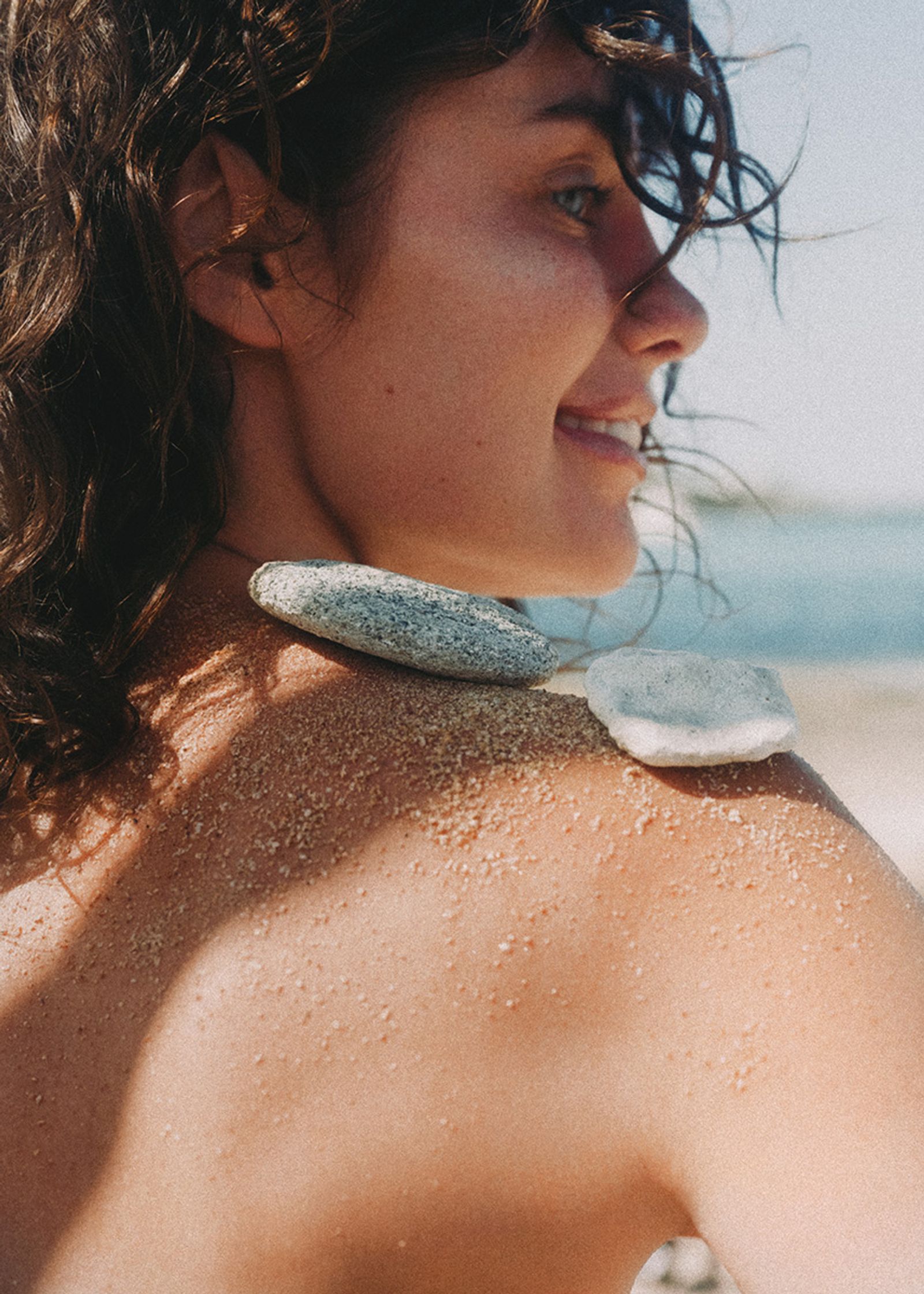 a woman with sand on her back