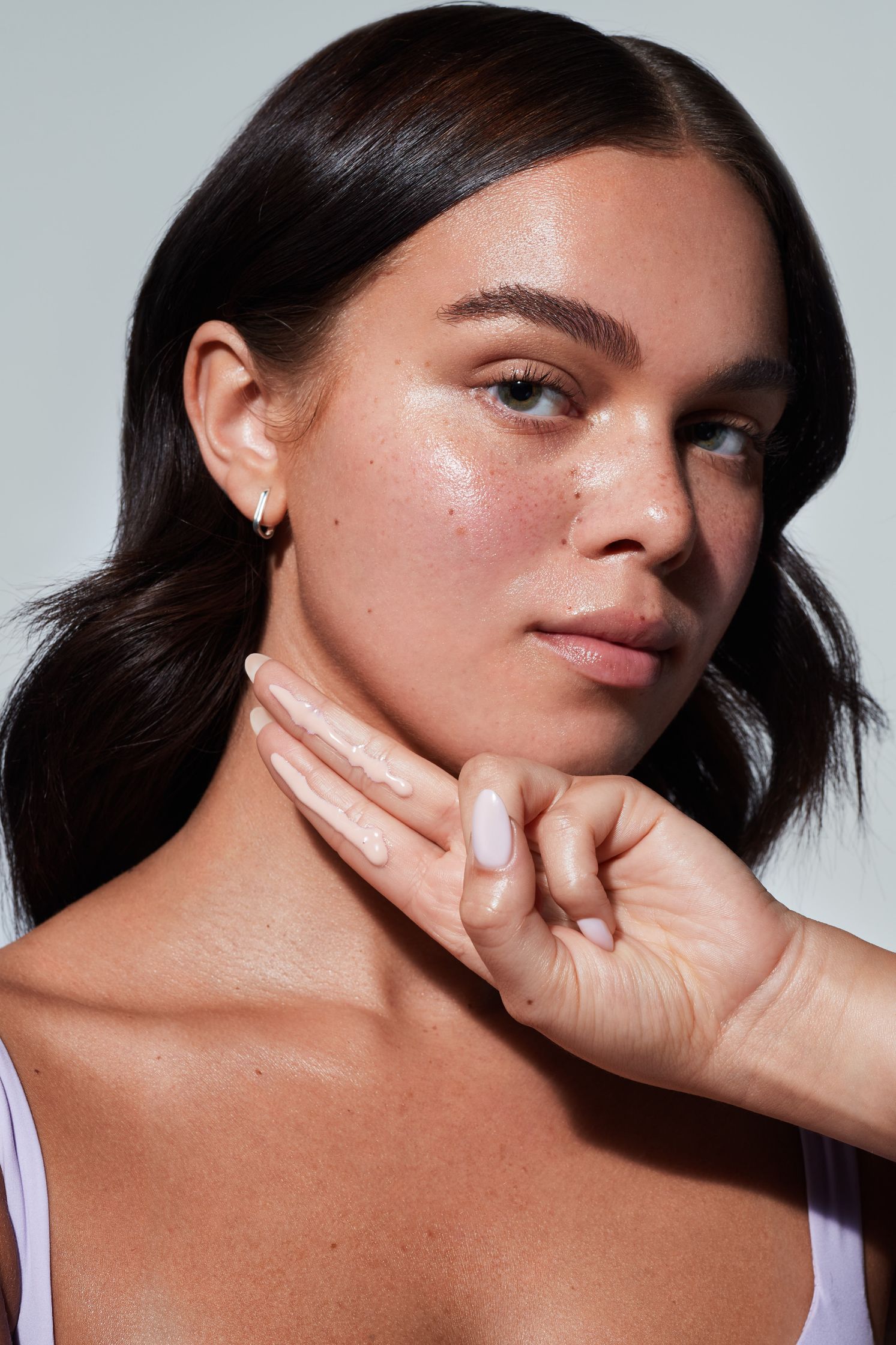 a woman is putting her hand on her face