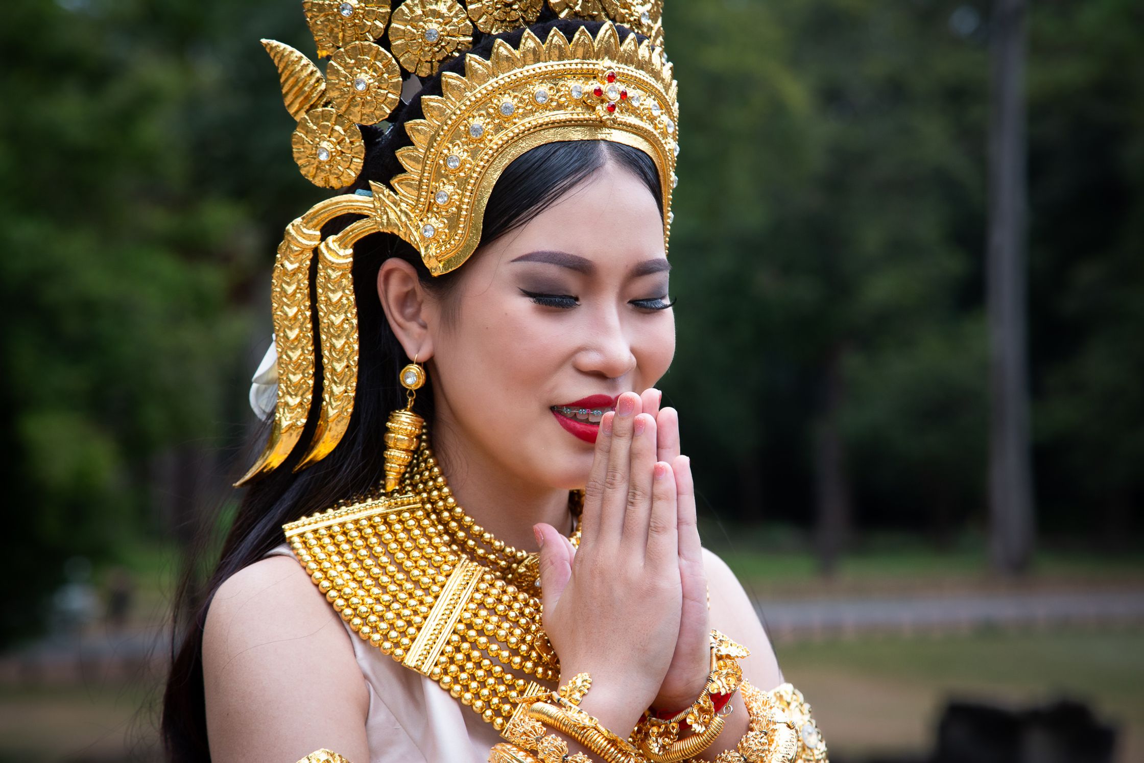a woman in traditional thai costume posing for a photo