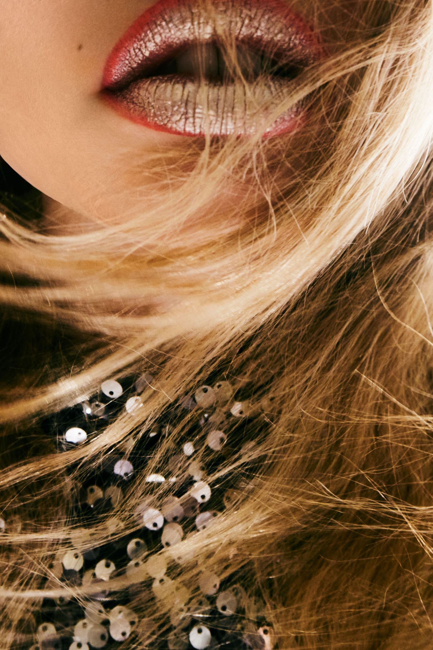 a woman with blond hair blowing in the wind