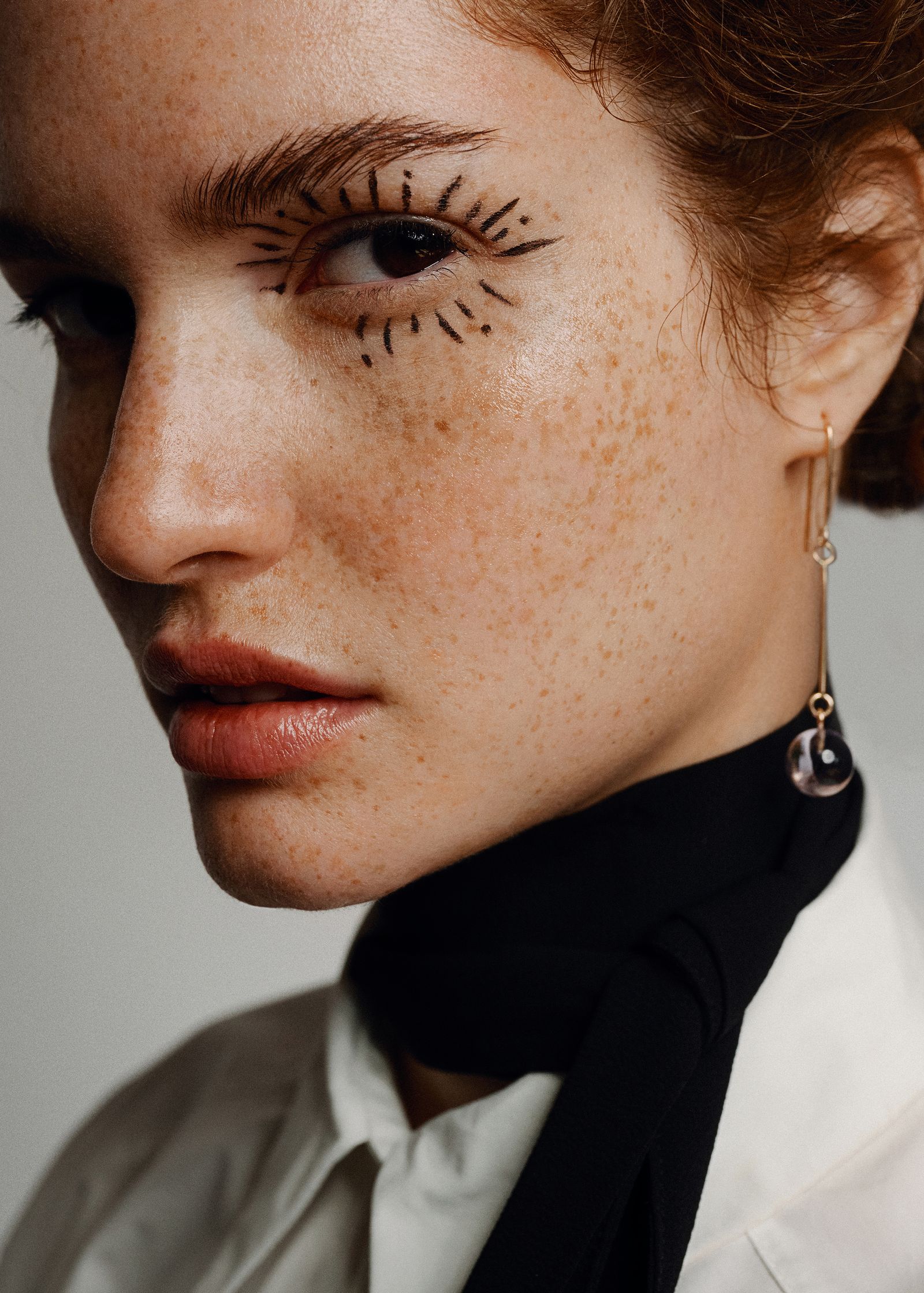 a woman with freckles on her face