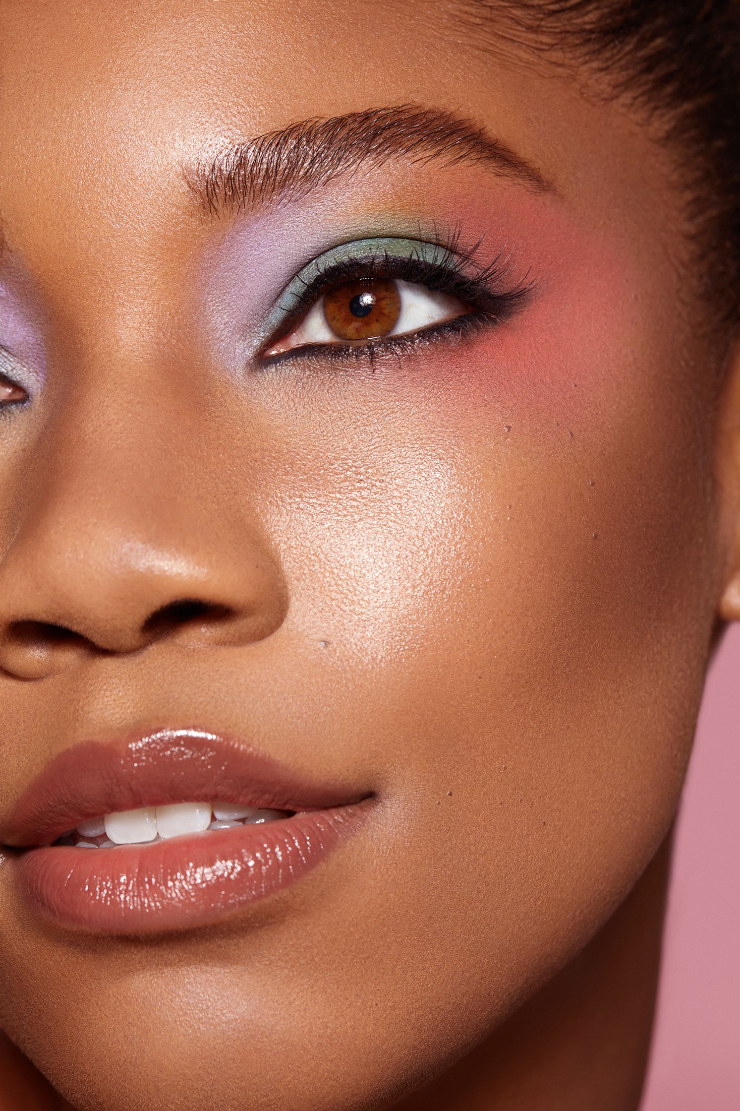 a black woman with colorful eye makeup