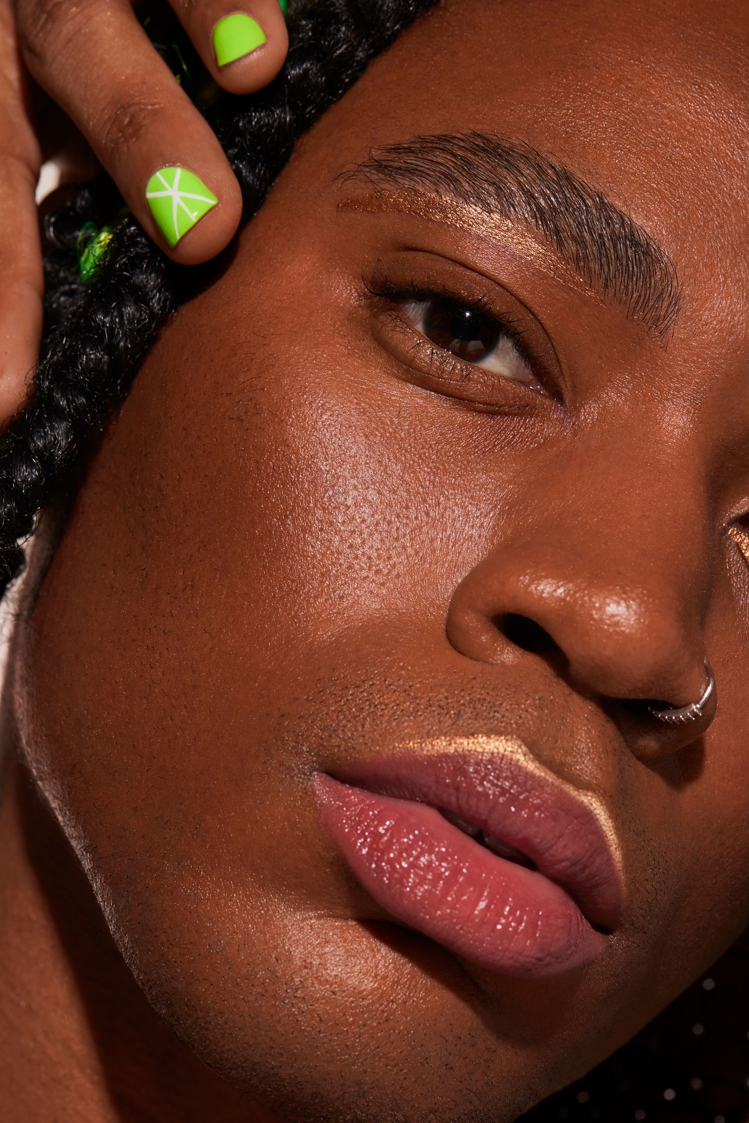 a black man with green nails and braids