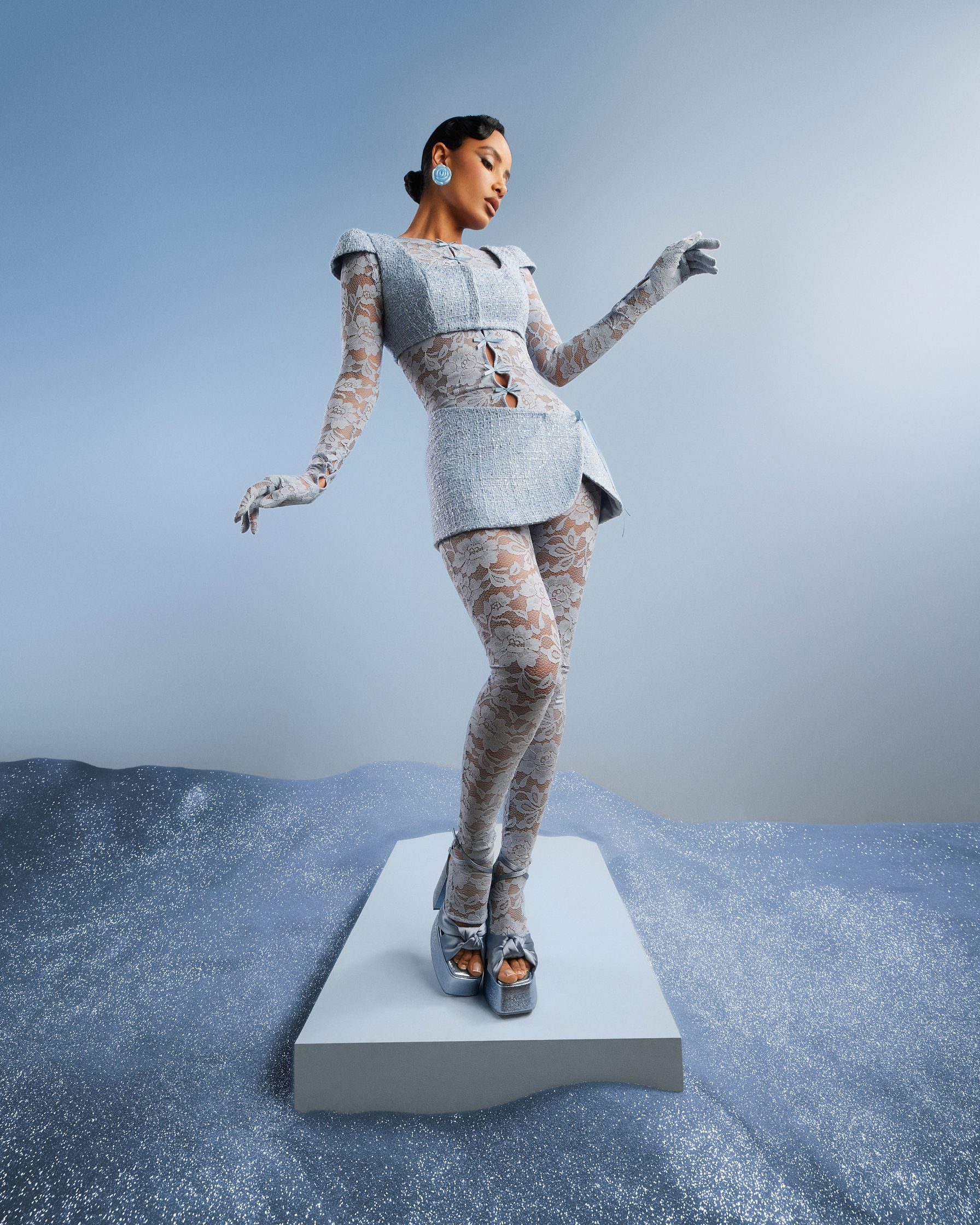 a woman is standing on a platform in the snow