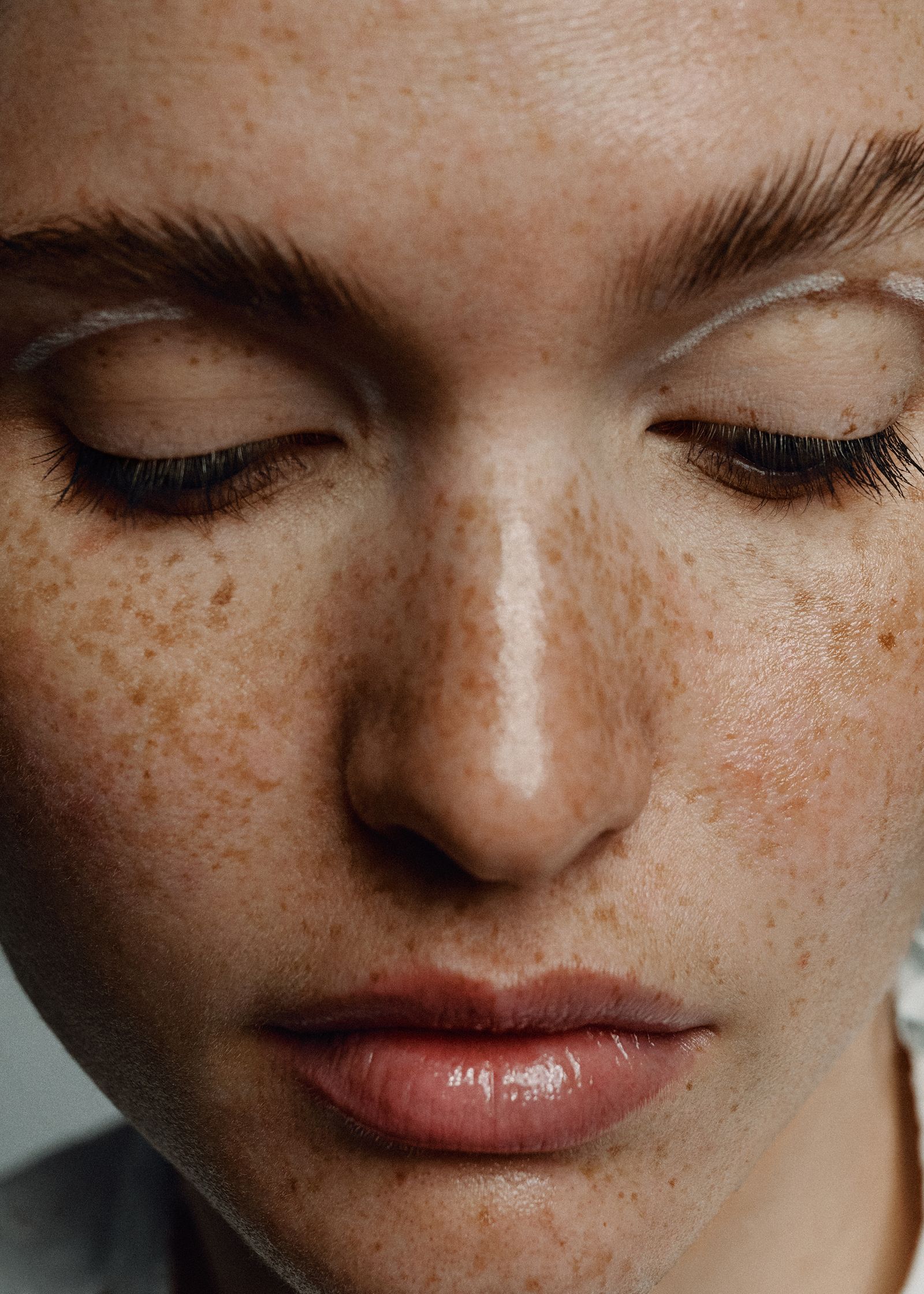 a close up of a woman with freckles on her face