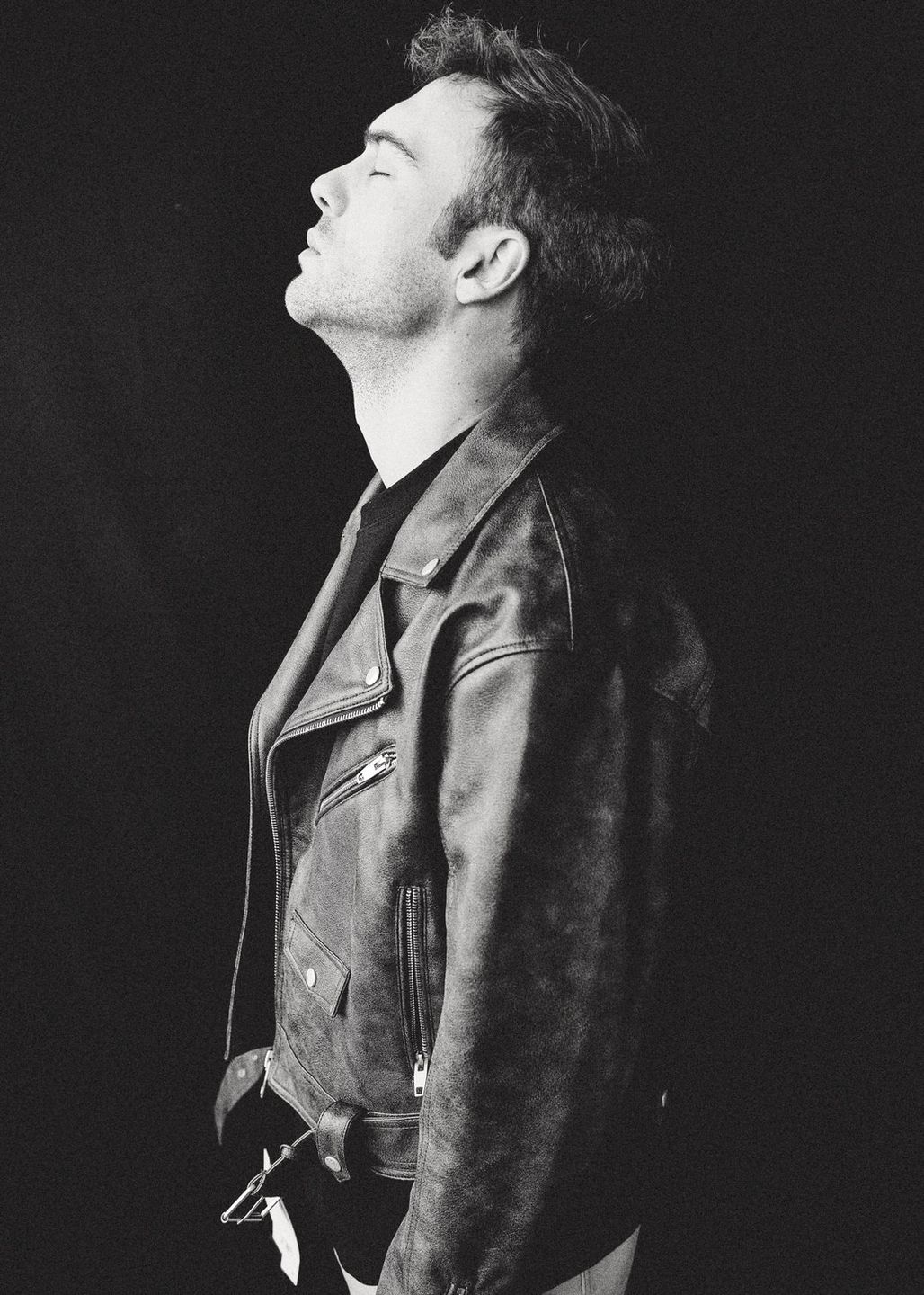a black and white photo of Malte Thomsan in a leather jacket by Martin Kula, photographer