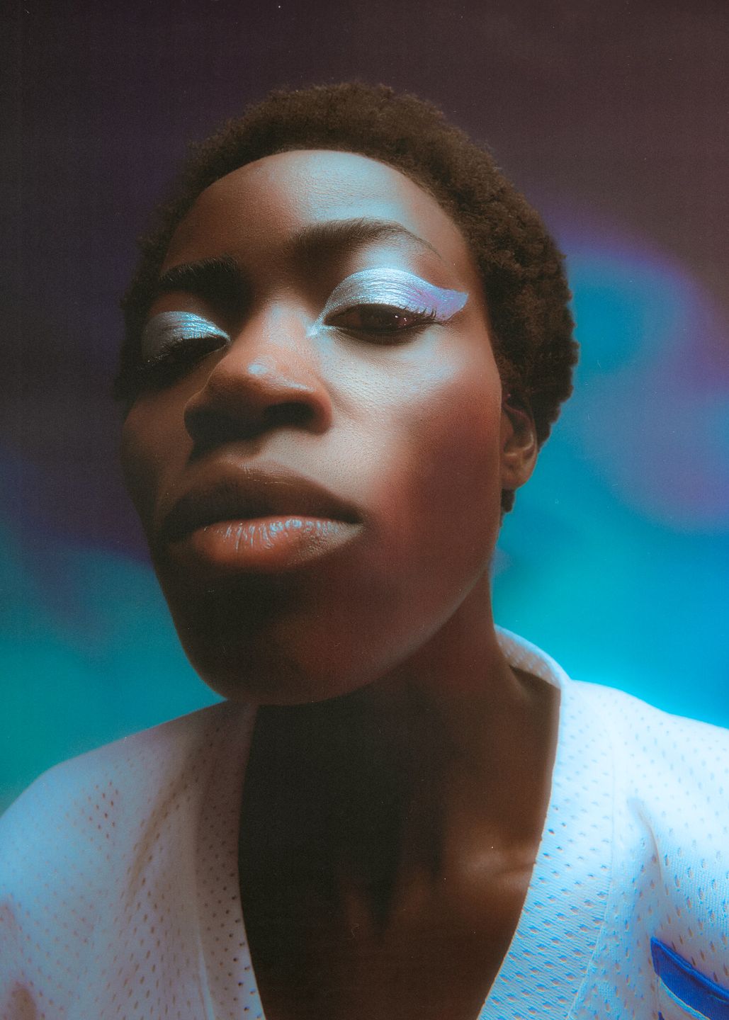 a portrait of a black woman with white eye makeup by Martin Kula