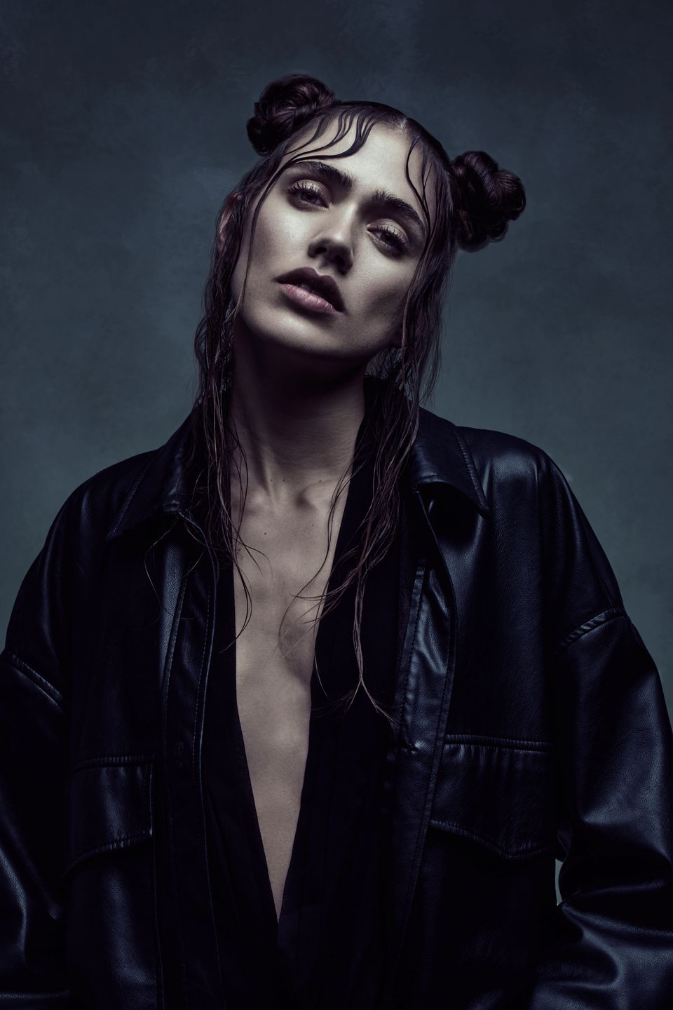 Close-up of model Ilona Gachet with wet, styled hair and a dark, minimalist aesthetic reminiscent of The Matrix