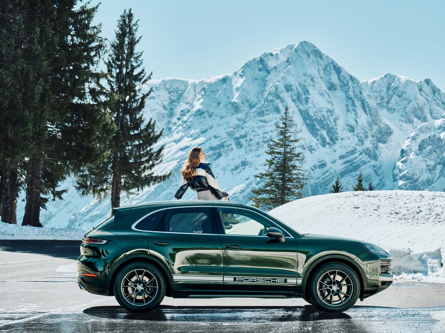 Porsche Cayenne in the snow with Eileen Gu on top of it photographed by  Martin Kula