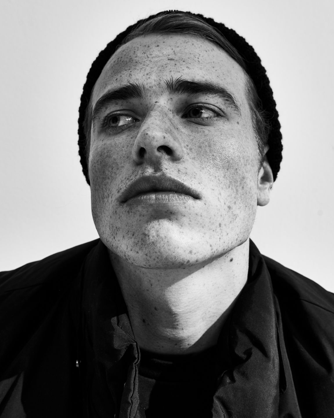 a black and white photo of a man with freckles by Martin Kula, photographer