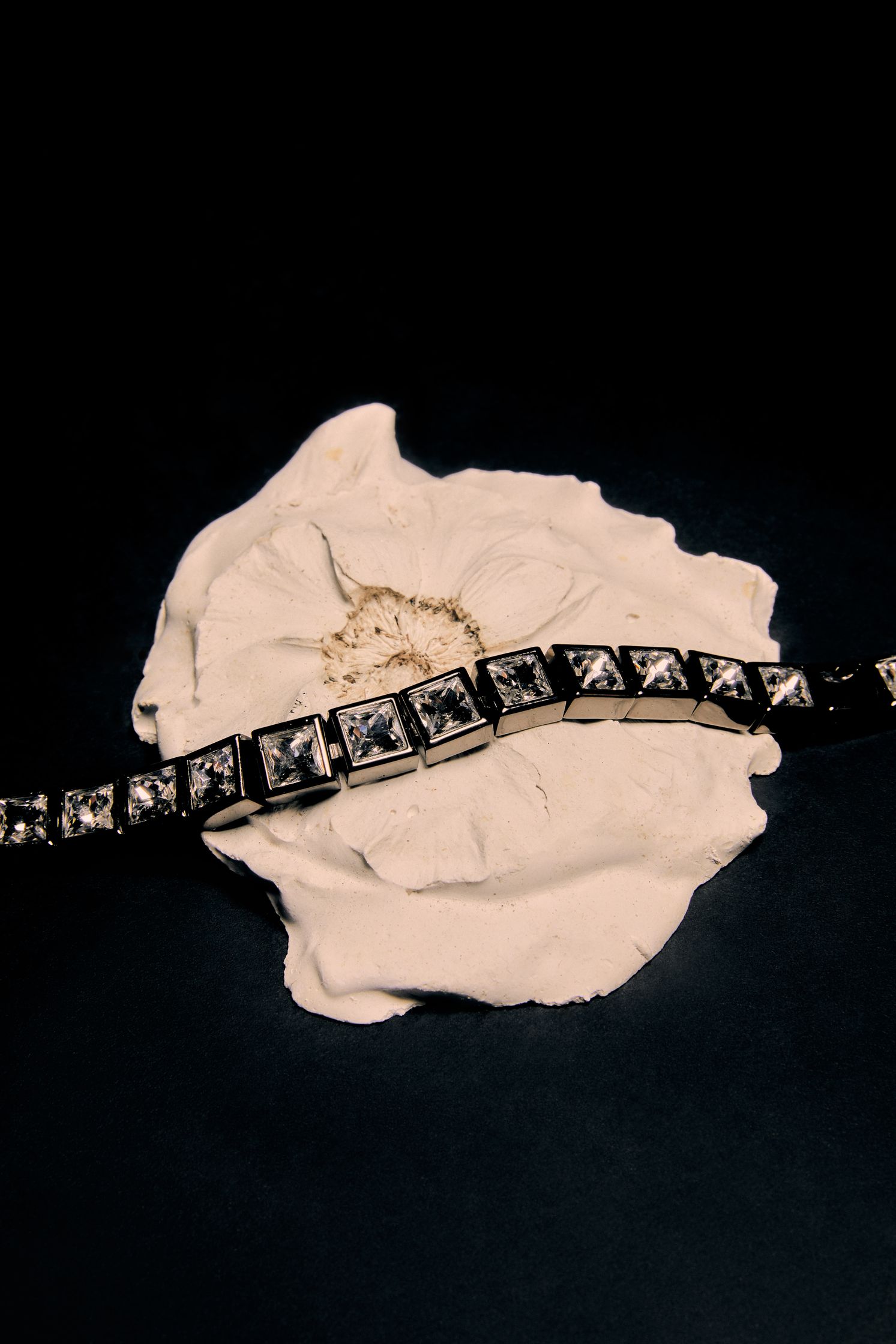 a black and white bracelet on a white flower