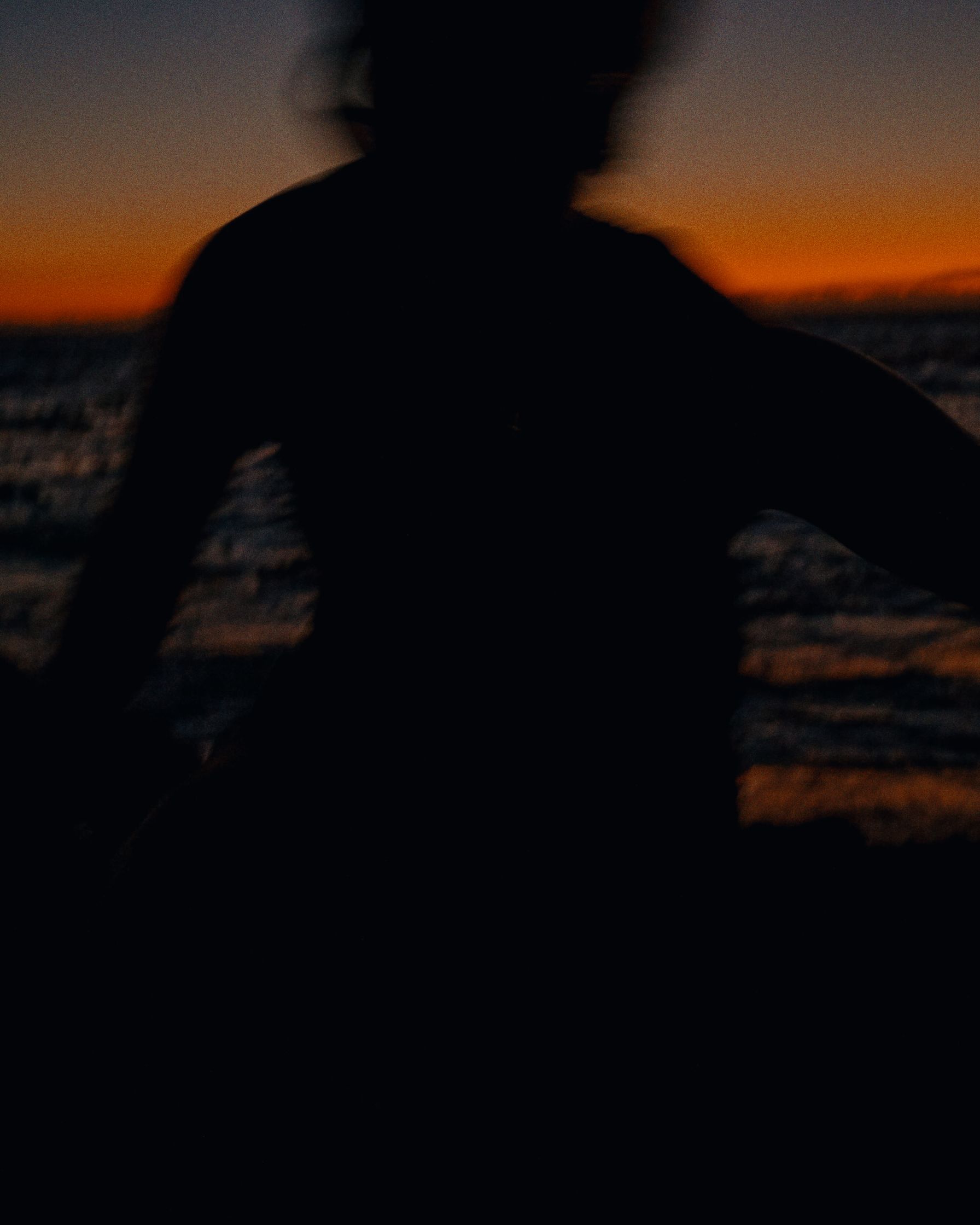 silhouette of a person riding a surfboard