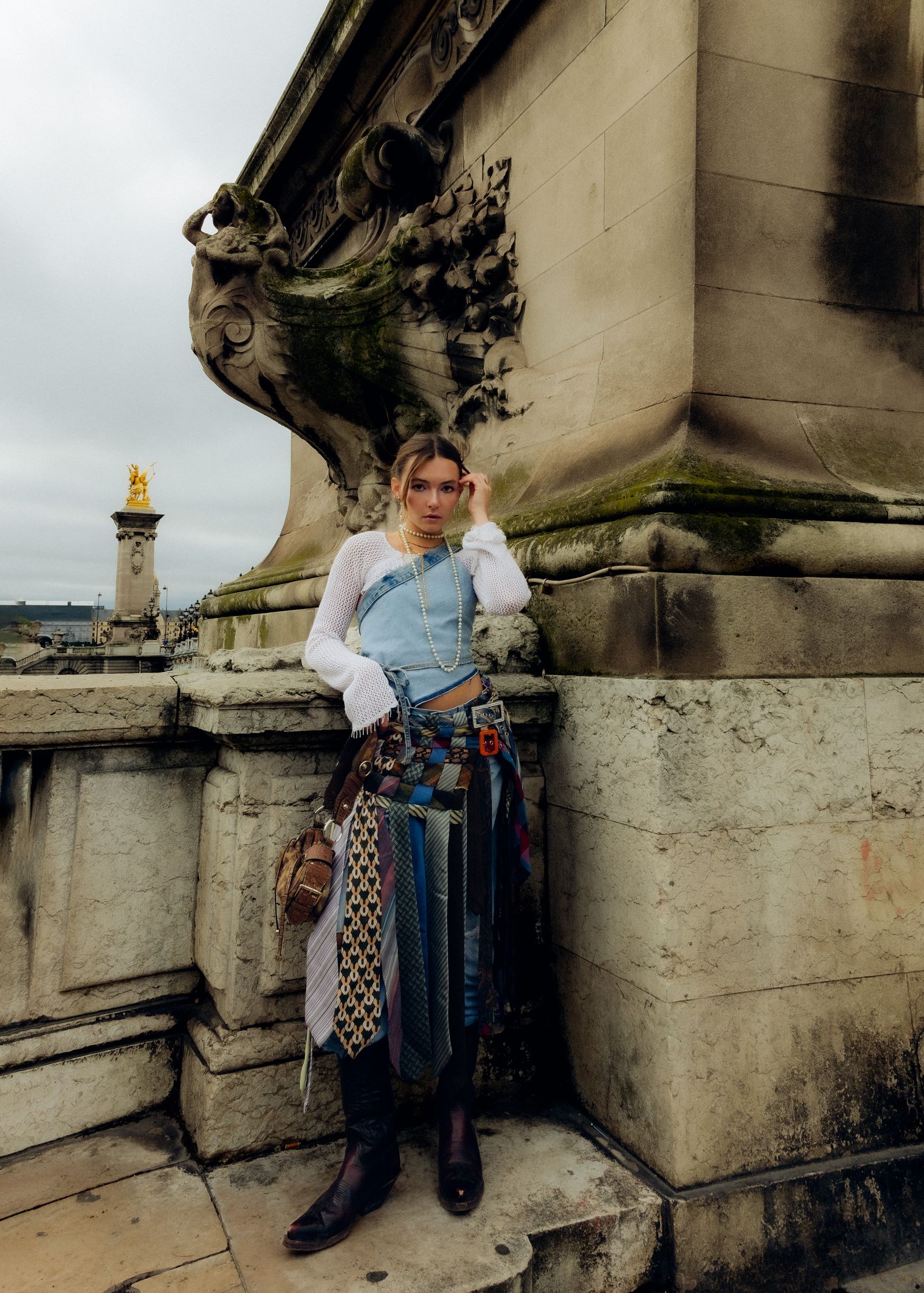 a fashion editorial portrait woman is posing for a photo on the eiffel tower