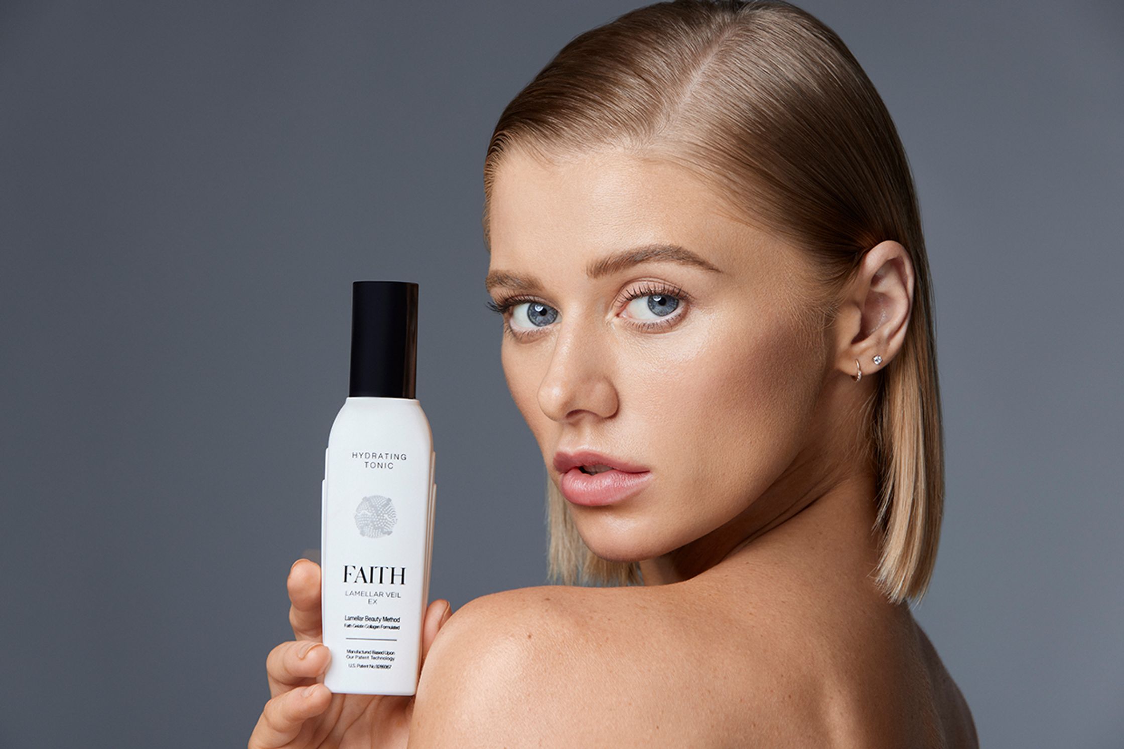 a woman is holding a bottle of hair care product