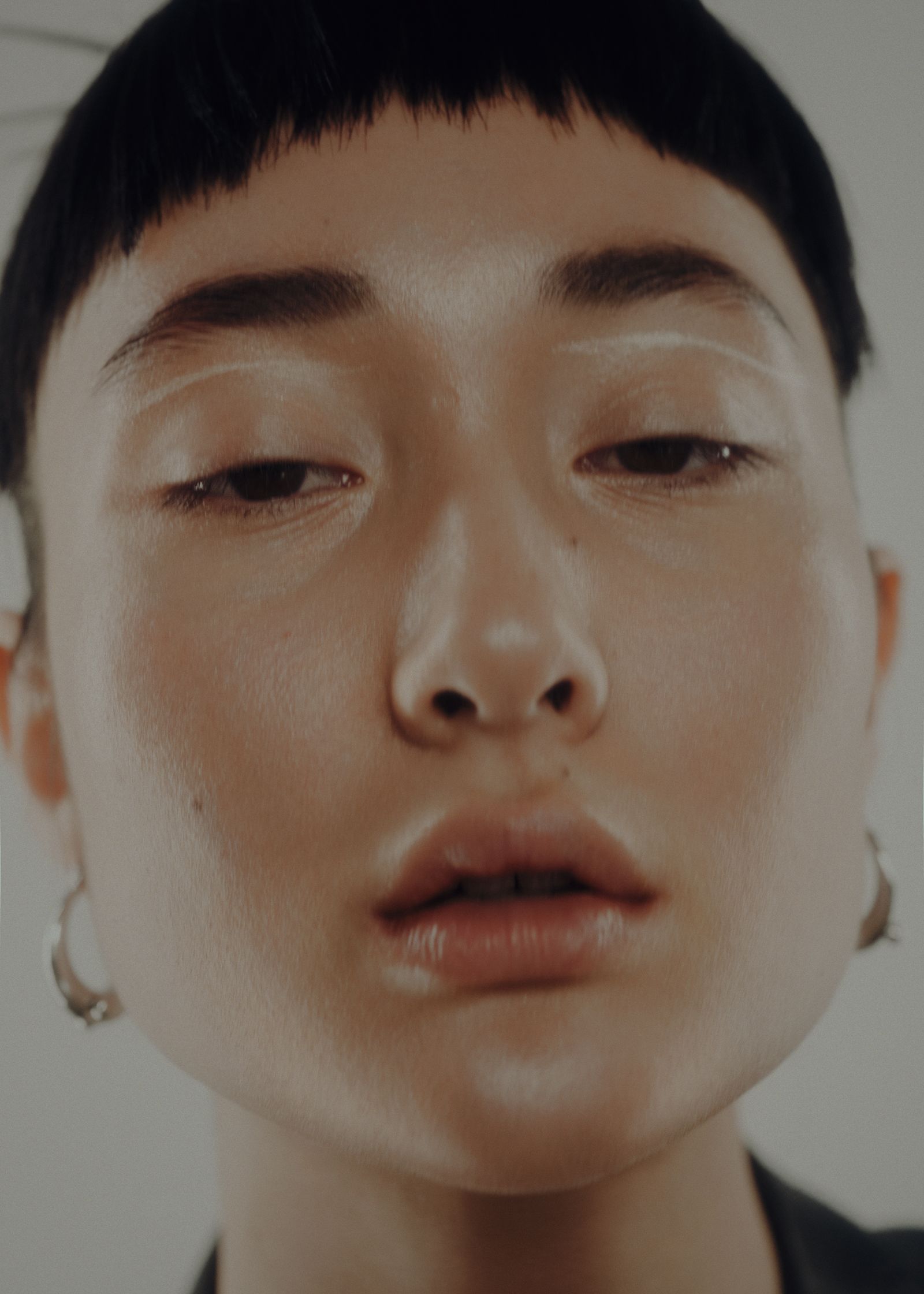 a woman with short hair and ear piercings