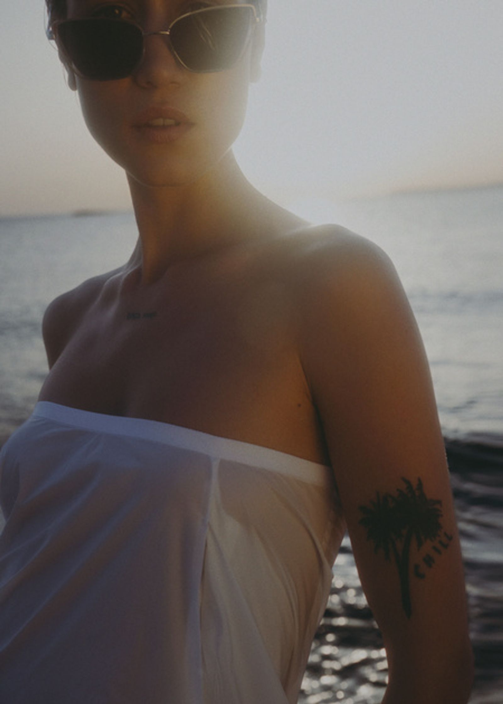 a woman wearing sunglasses on the beach