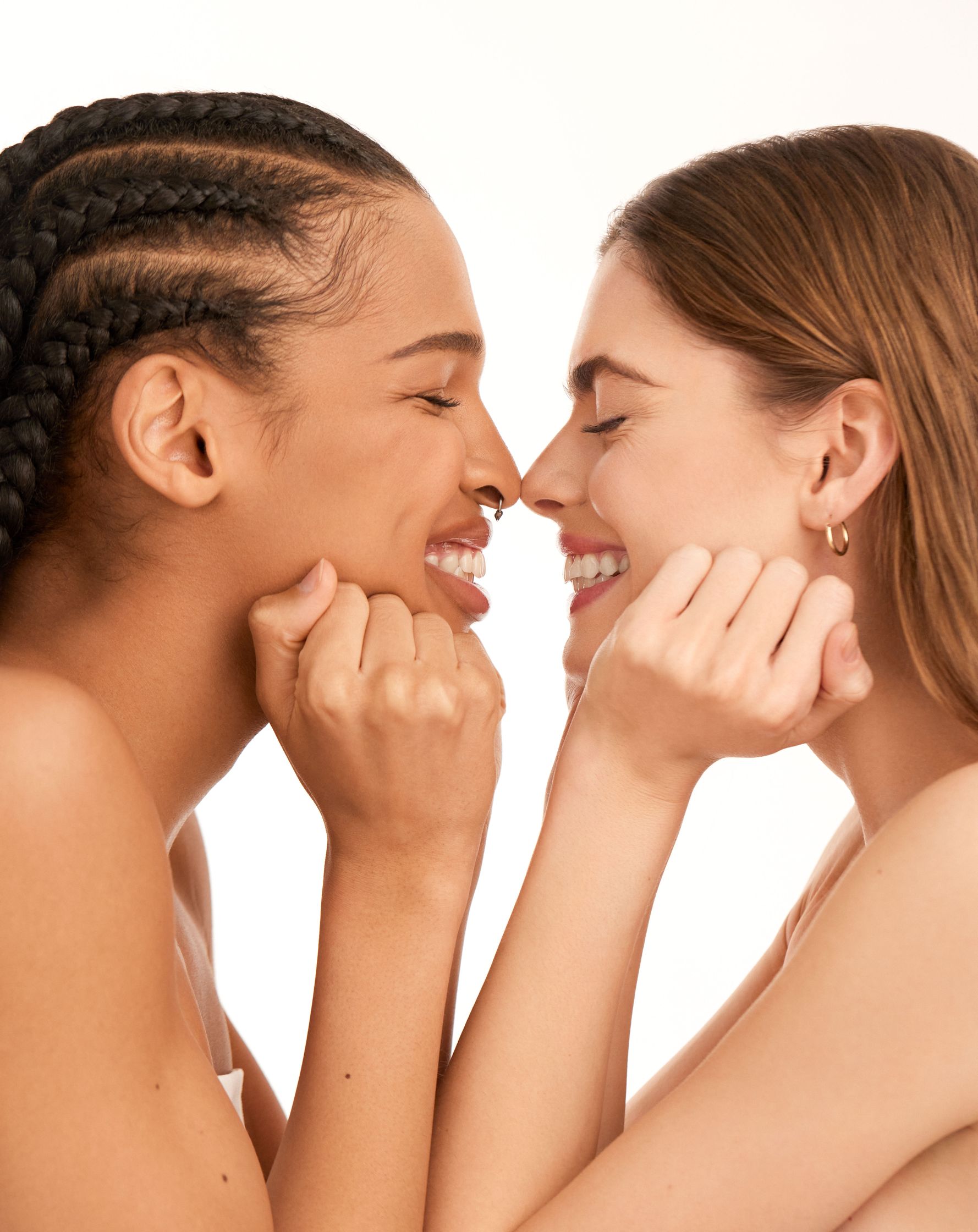 two women are looking at each other and smiling