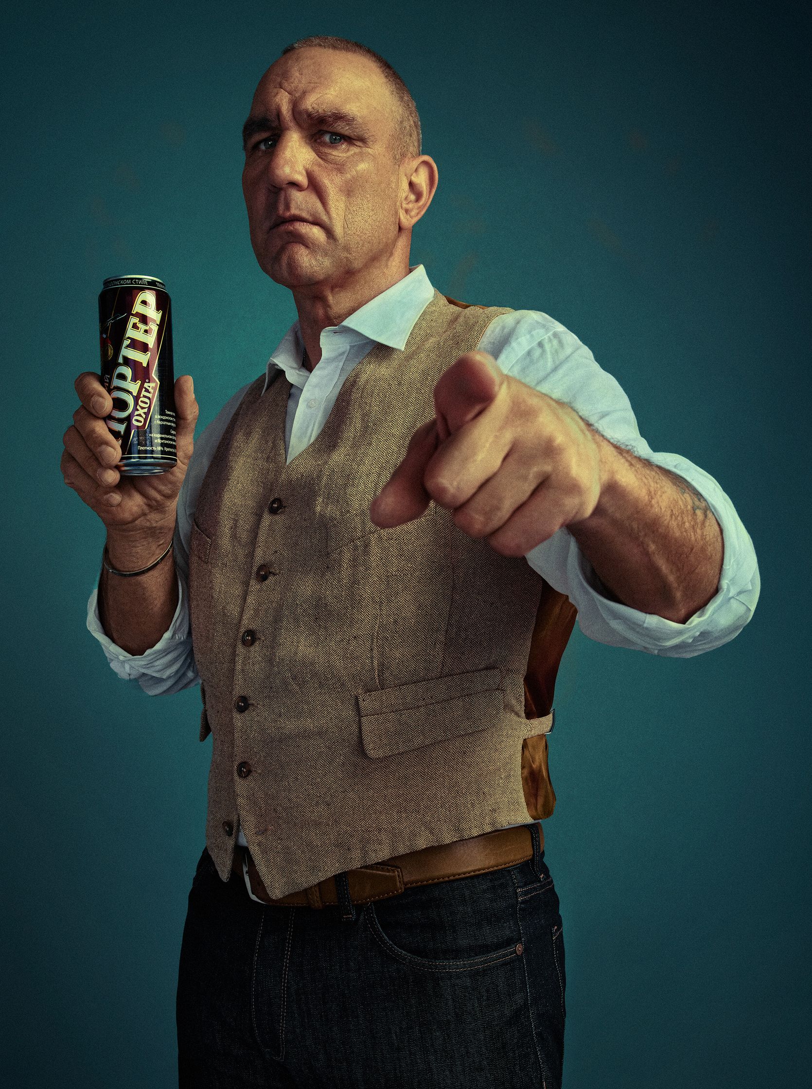 a man pointing at a can of beer