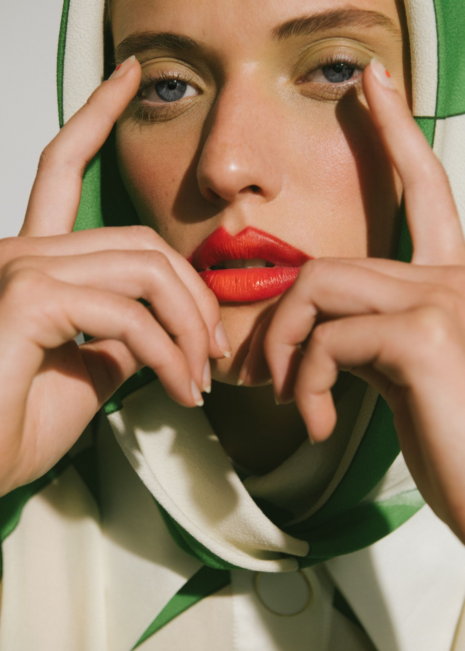 a woman wearing a green and white scarf