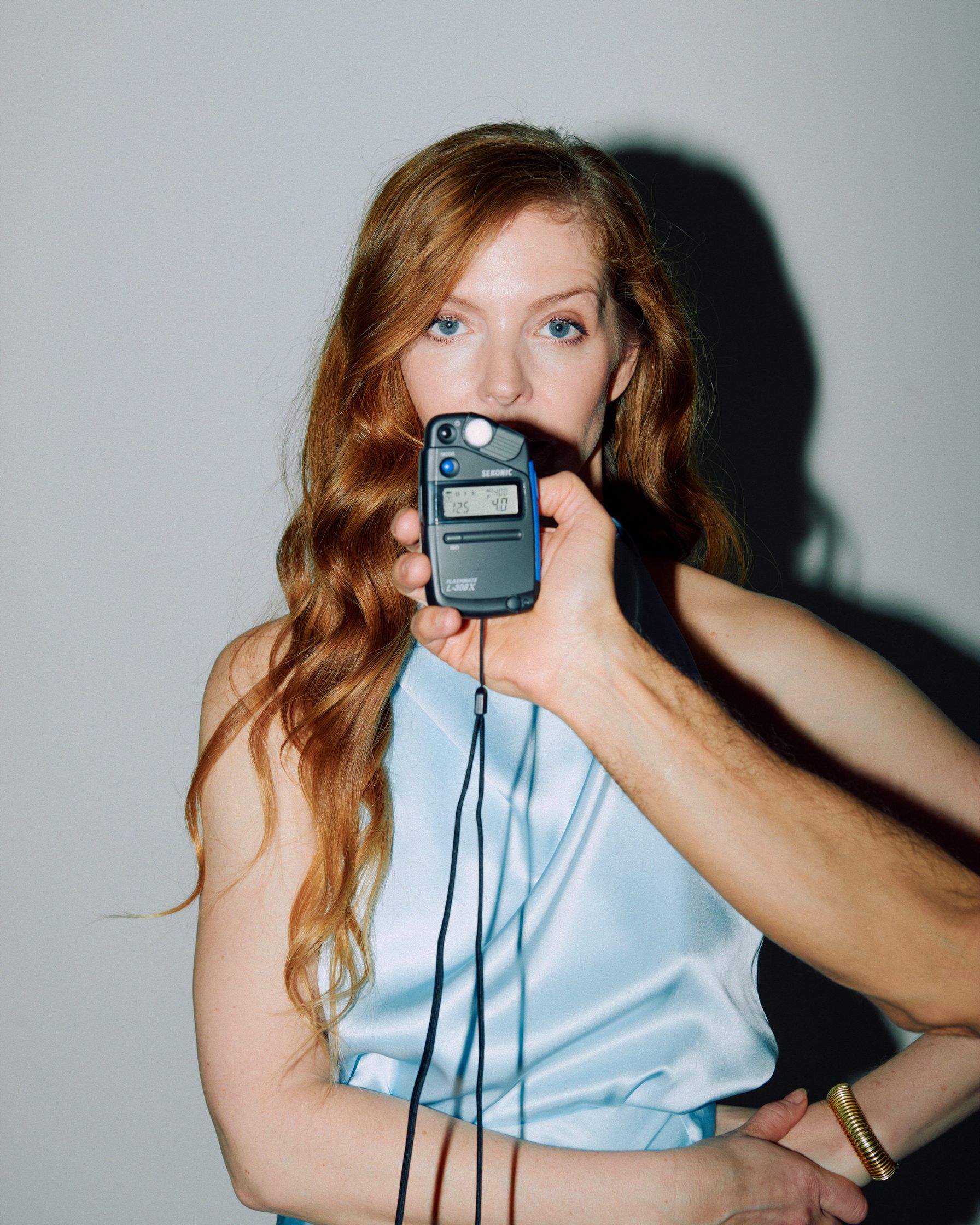 Pheline Roggan is holding a cell phone in her hand