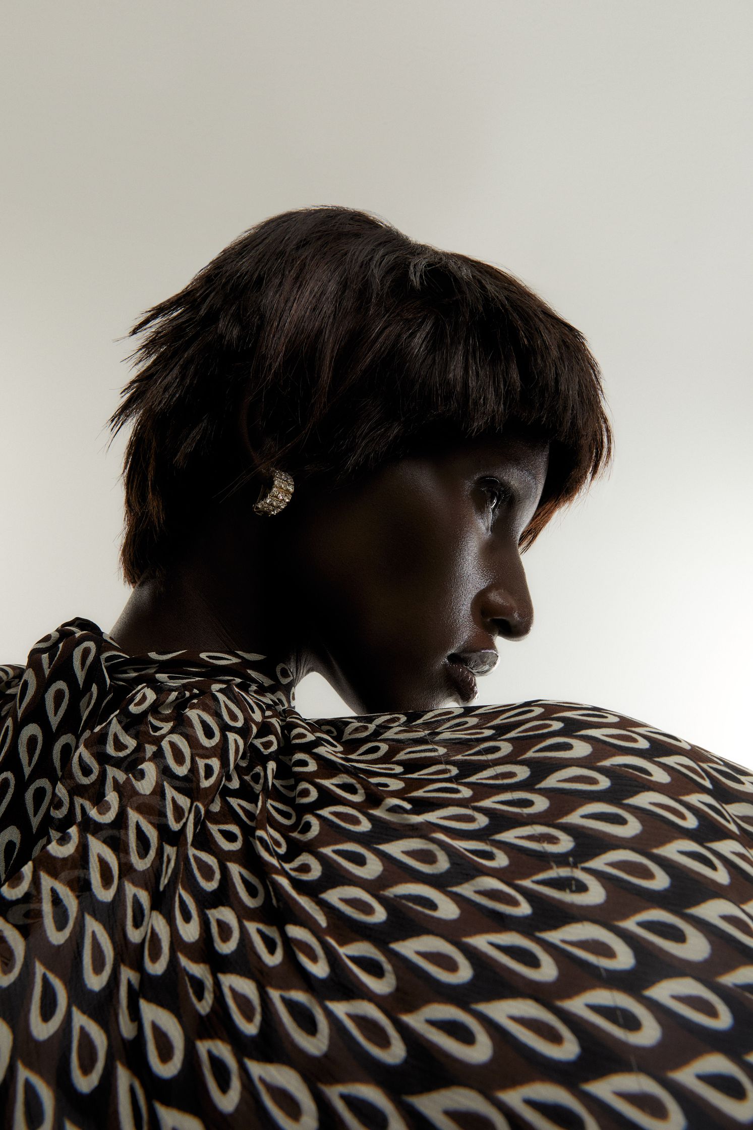 a woman in a black and white patterned dress