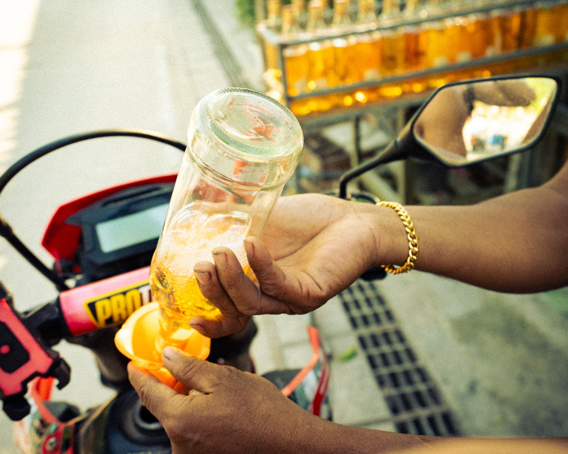 A local man refueling a motorbike at a roadside station in Koh Tao, capturing the lifestyle and the daily flow of Koh Tao.
