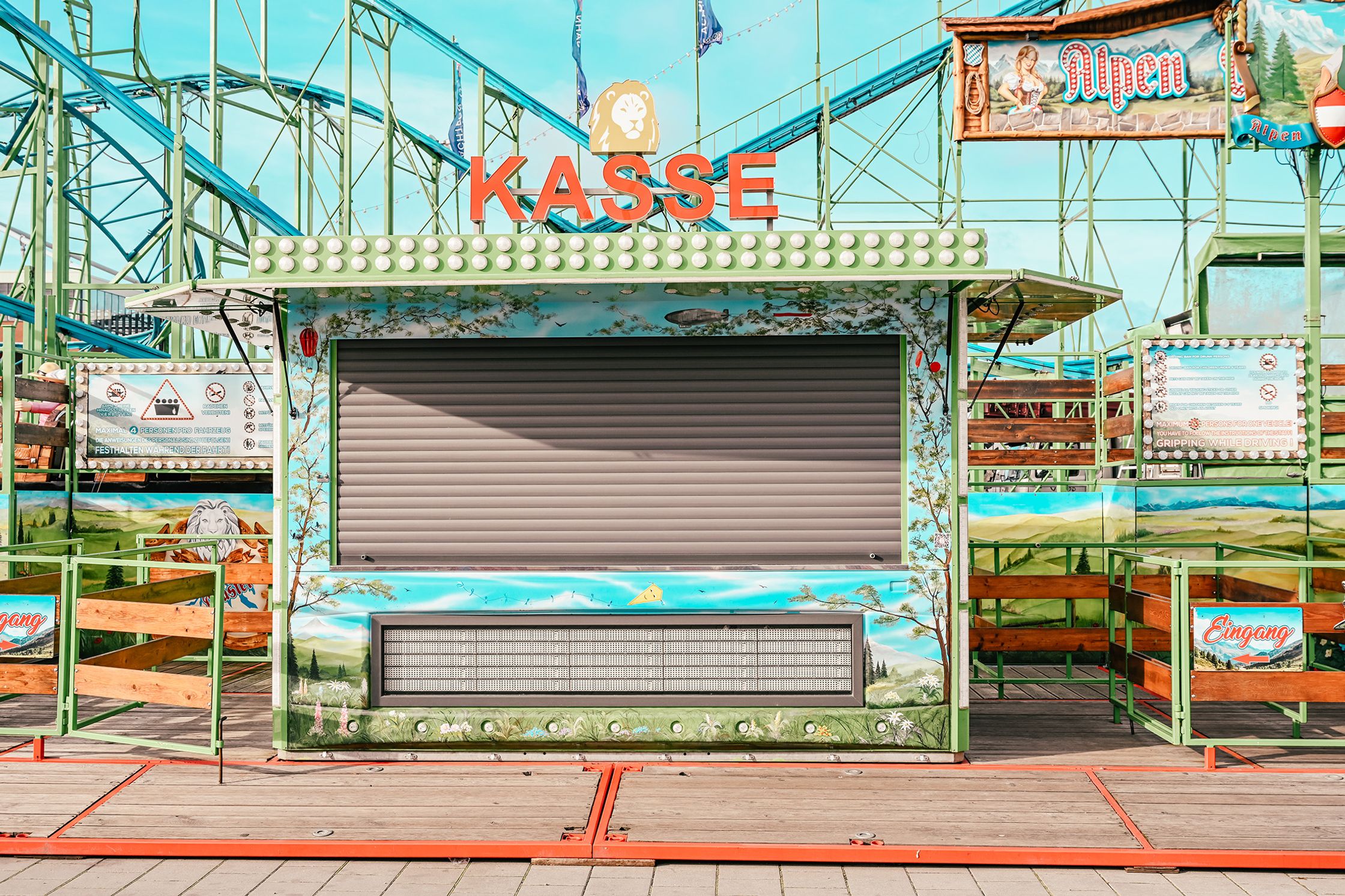 an amusement park with a roller coaster in the background