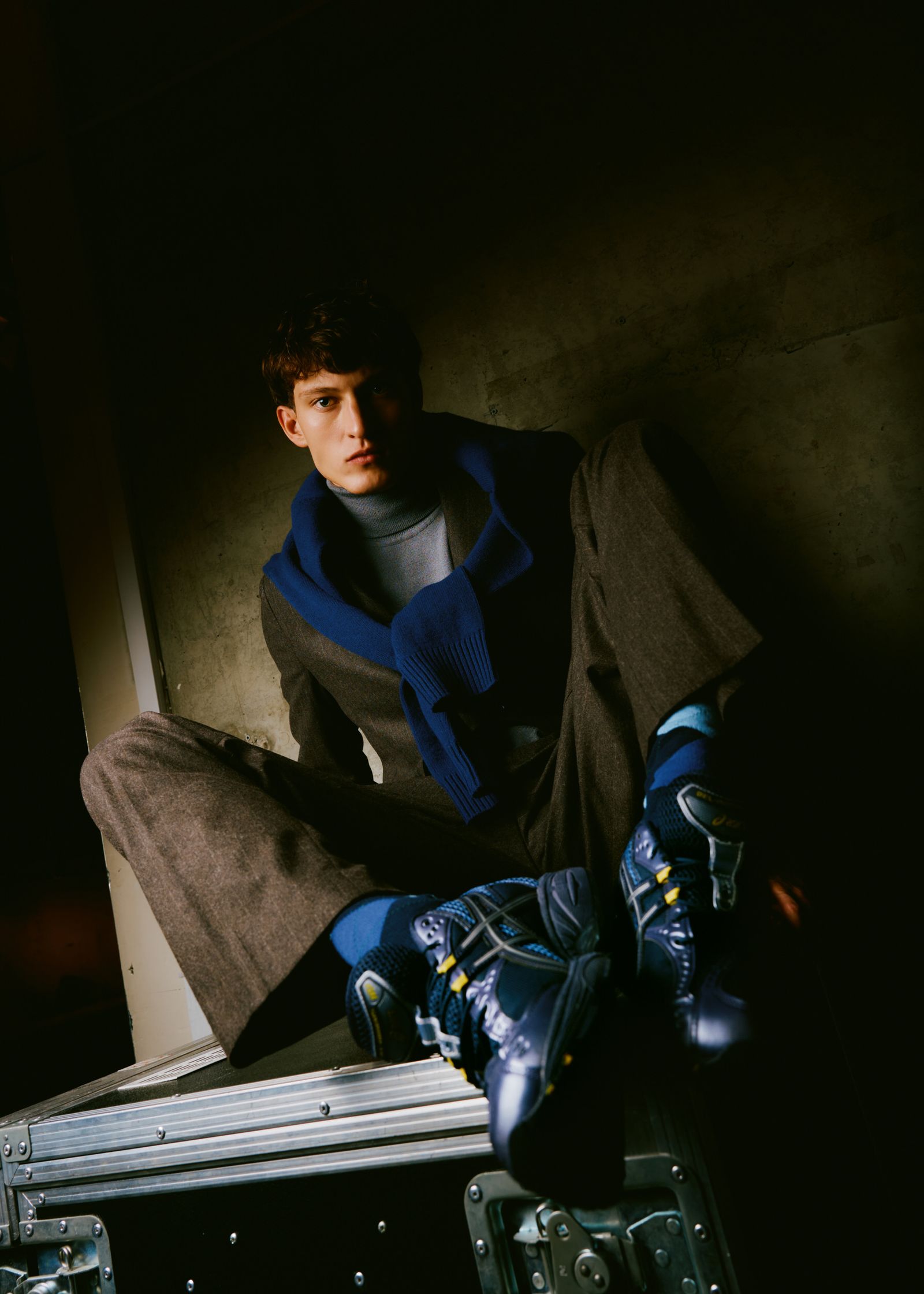 a man sitting on a suitcase