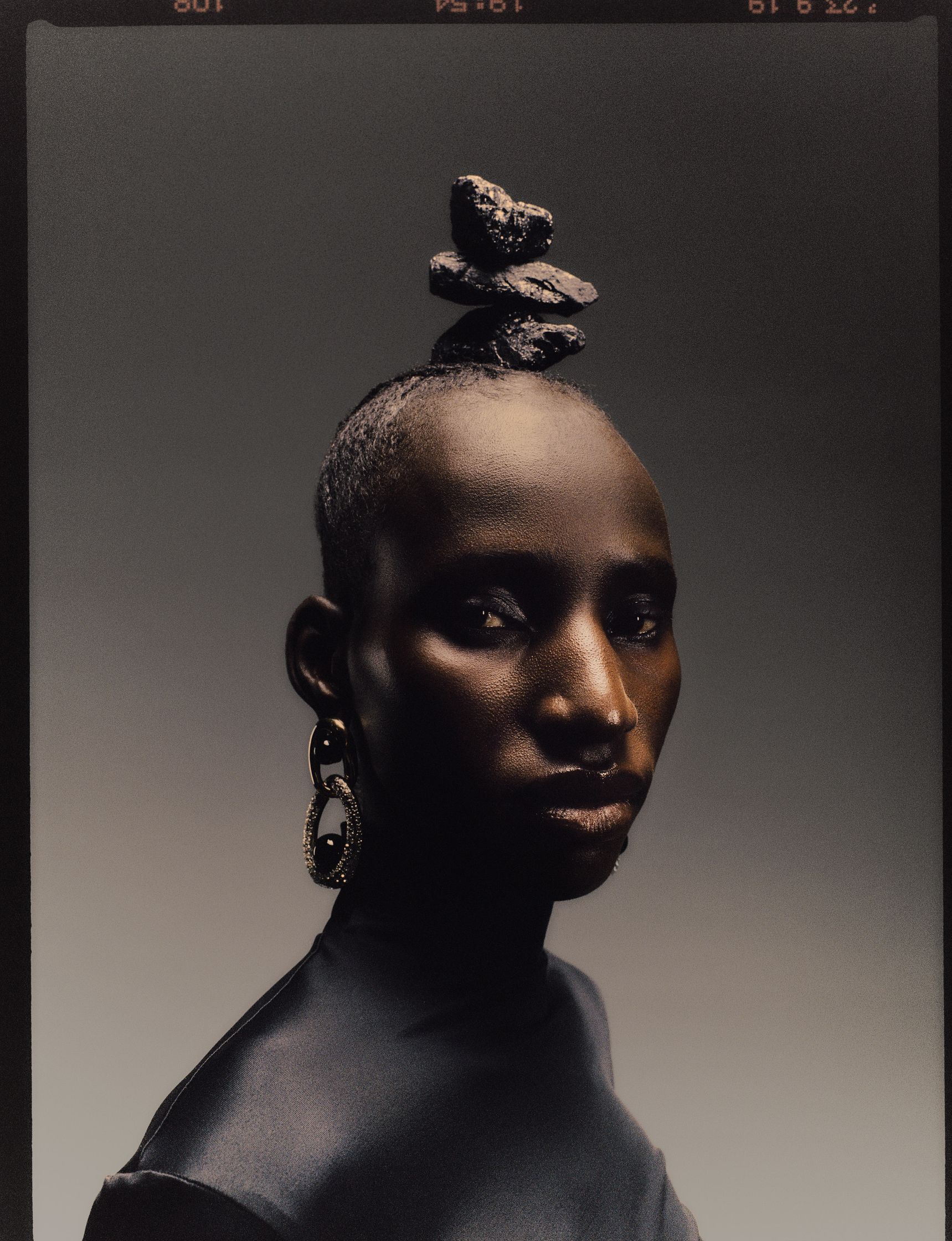 a black woman with stones on her head