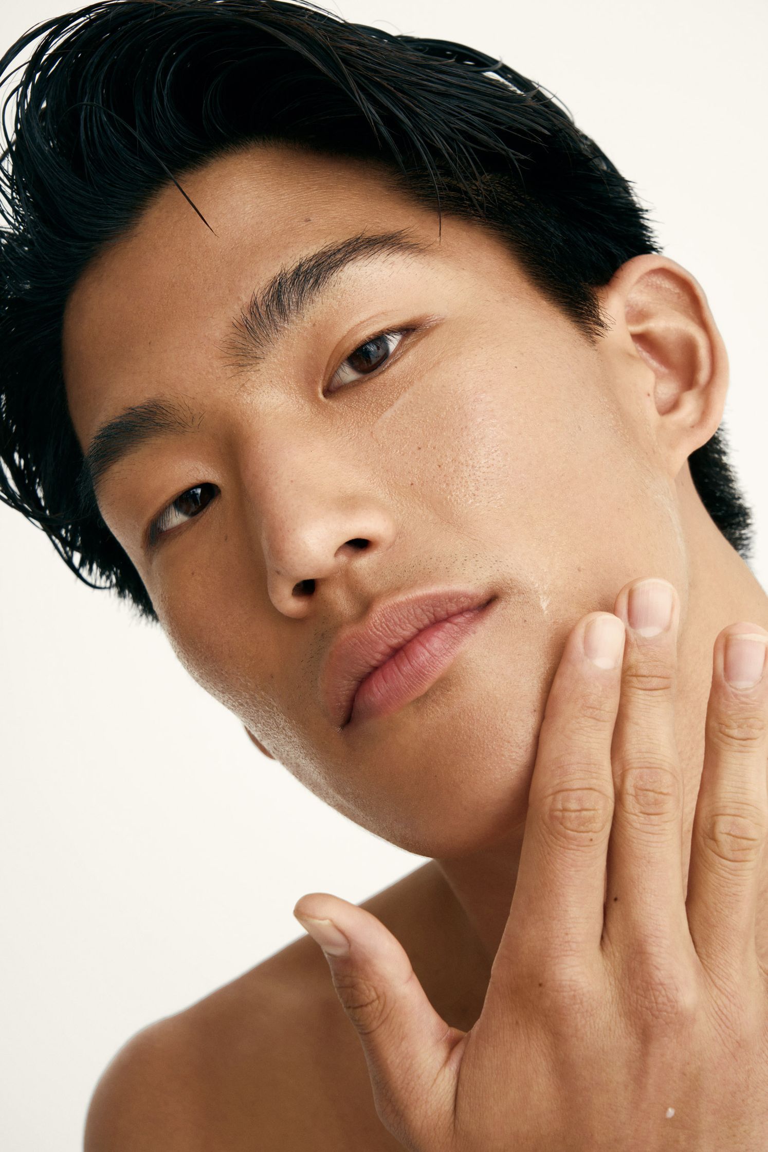 a man is putting his hand on his face