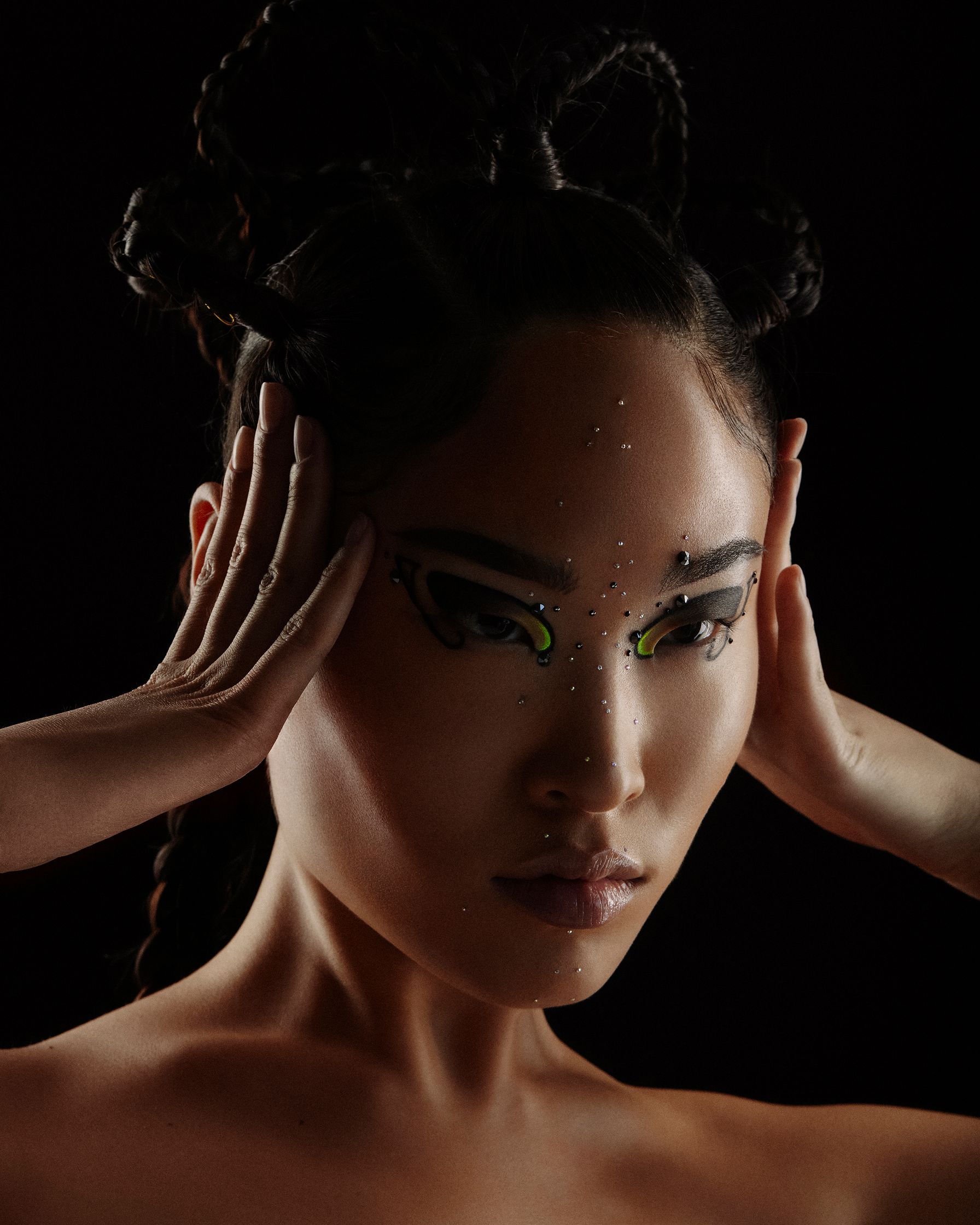 a woman with green eyes and a black background