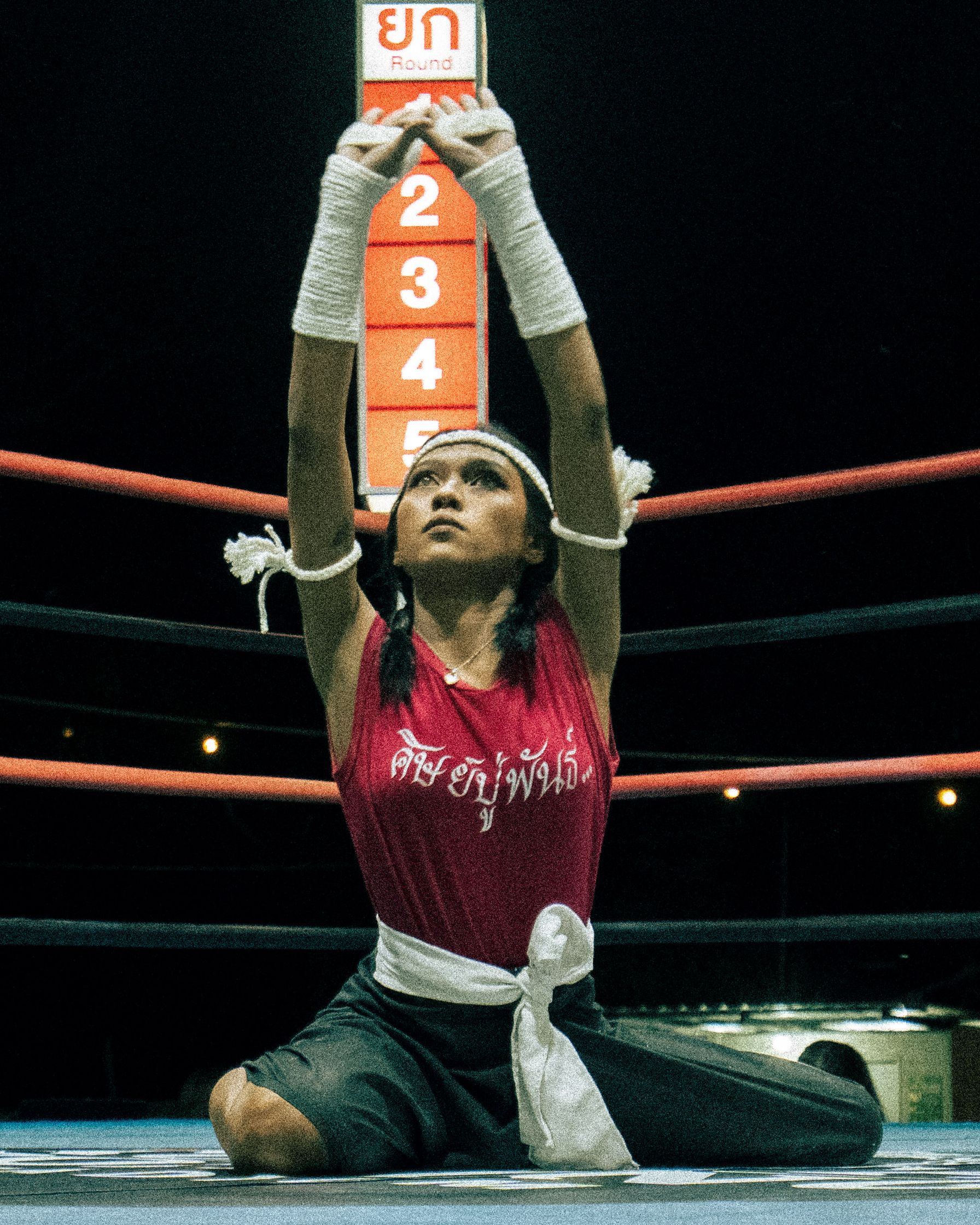 A woman performing the sacred Wai Khru Ram Muay ritual dance before the fight. A powerful moment of respect and heritage at Koh Tao.