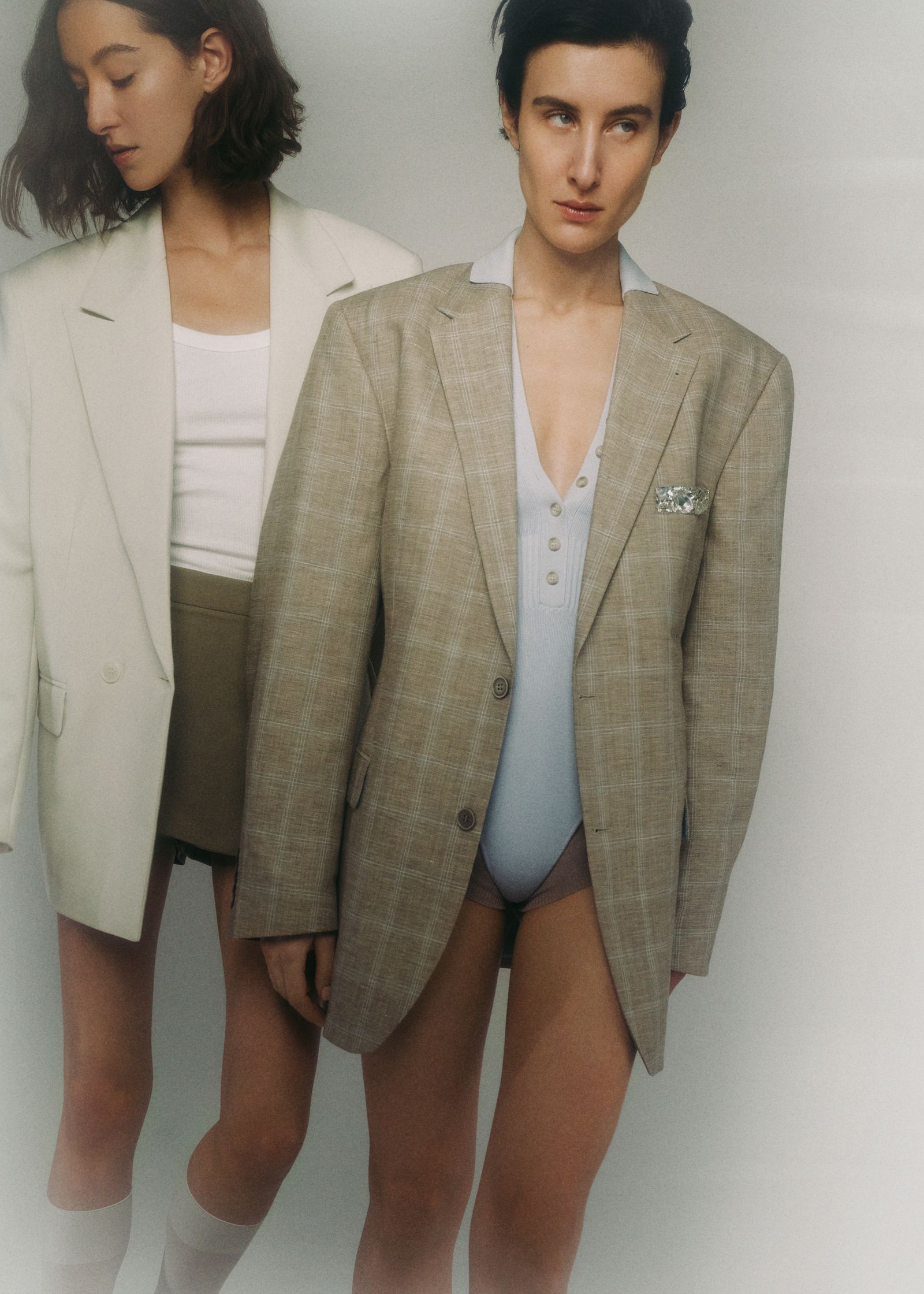 a woman in a blazer and shorts