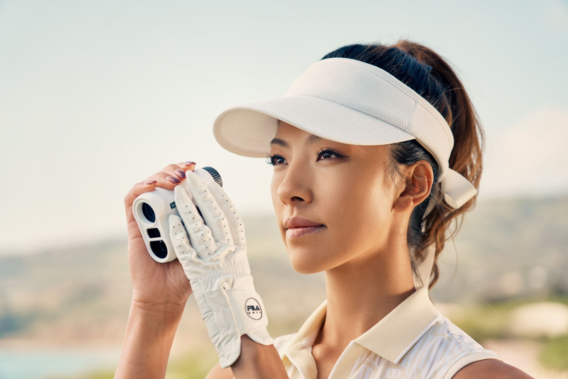a woman holding a golf ball in her hand