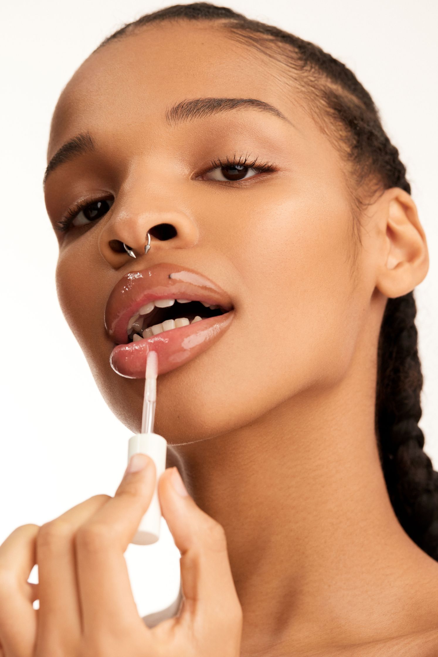 a woman is putting lipstick on her lips