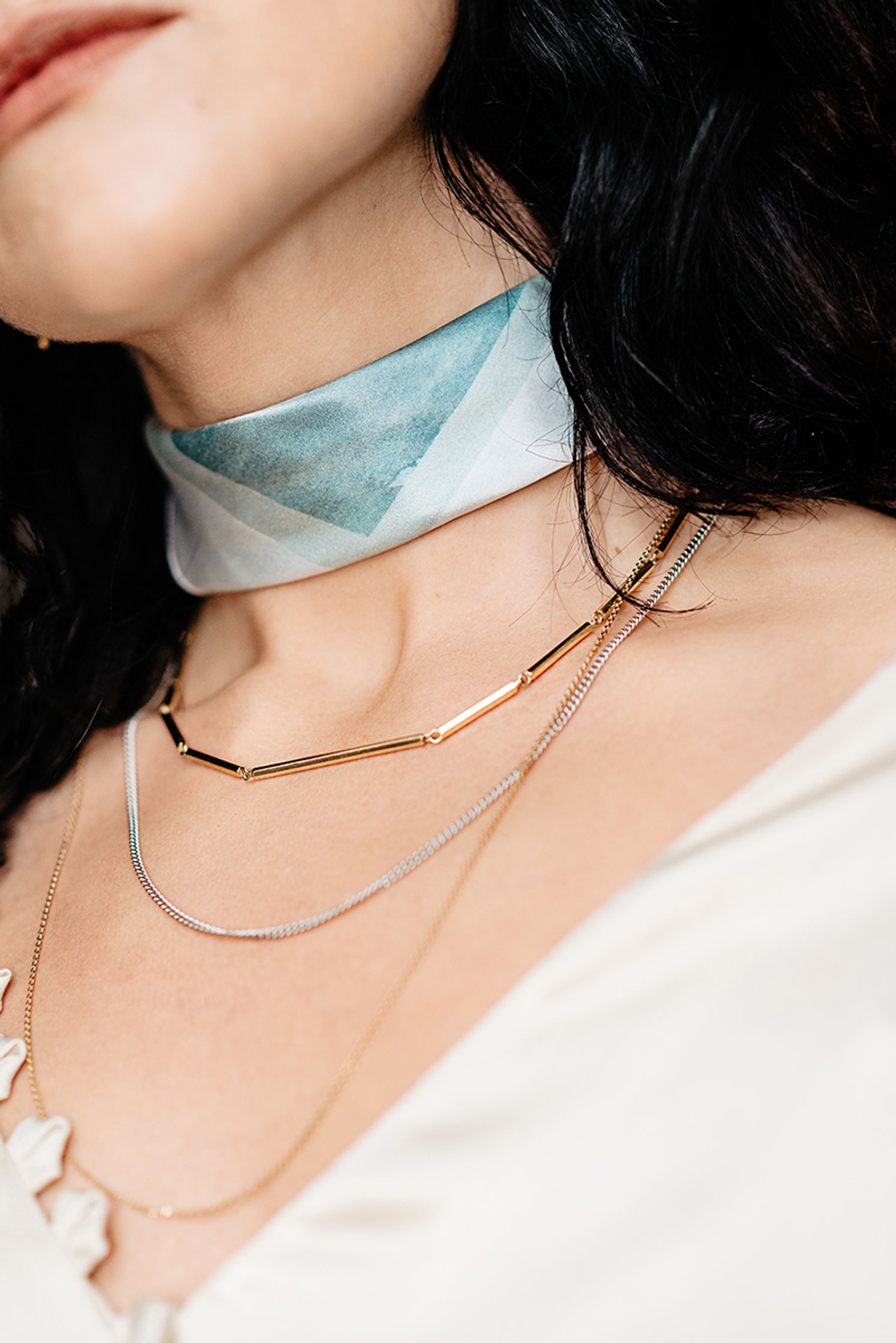a woman is wearing a maren jewellery necklace and a choker
