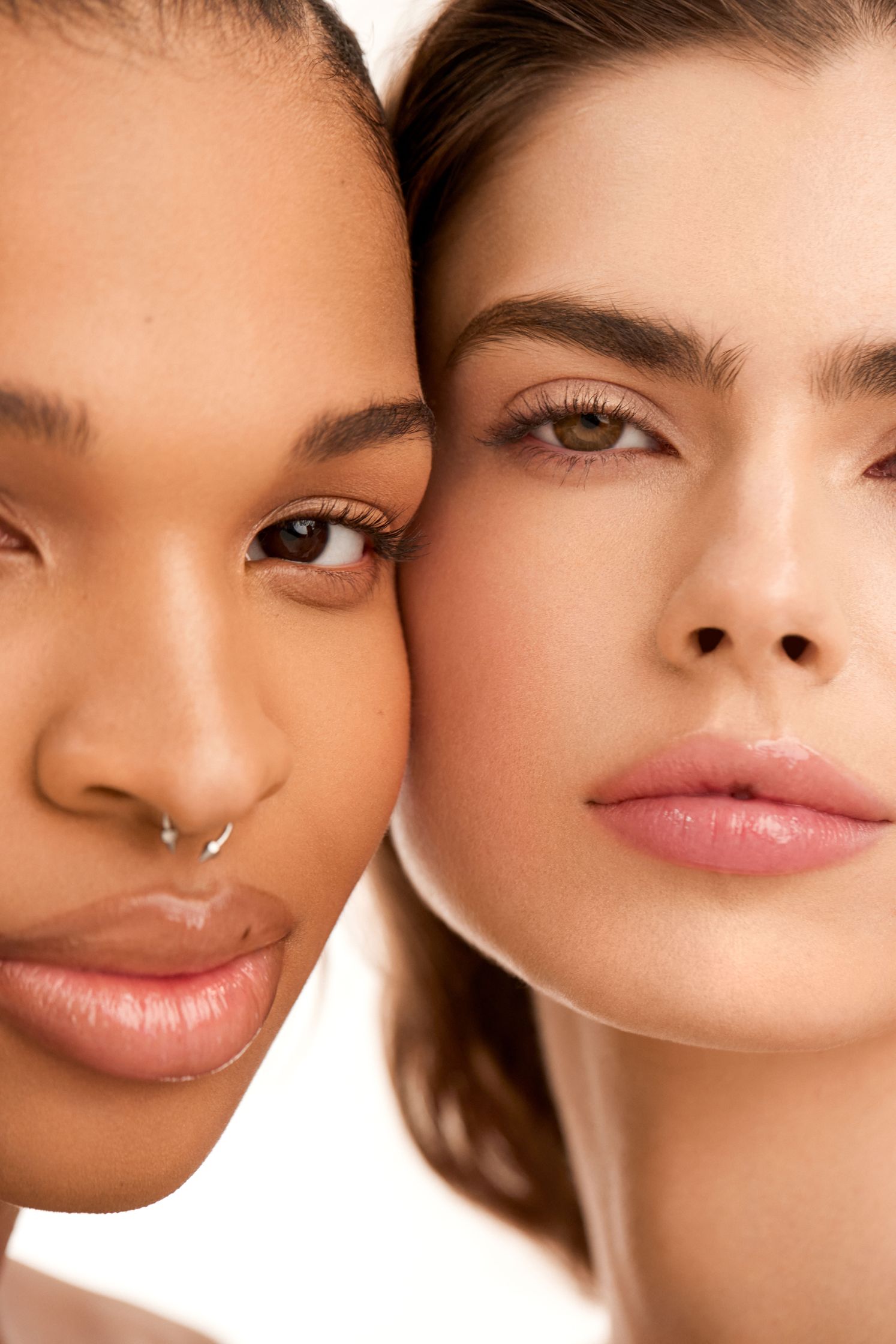 two women posing for a photo with piercings