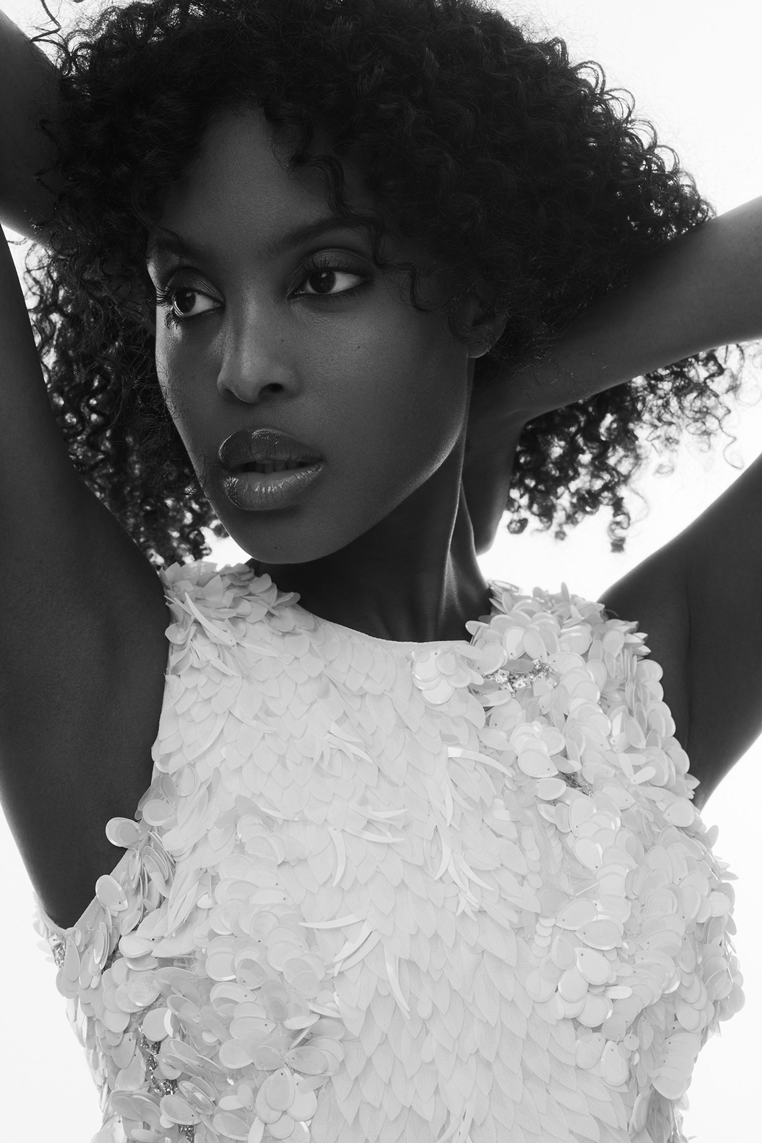 a black and white photo of a woman with curly hair