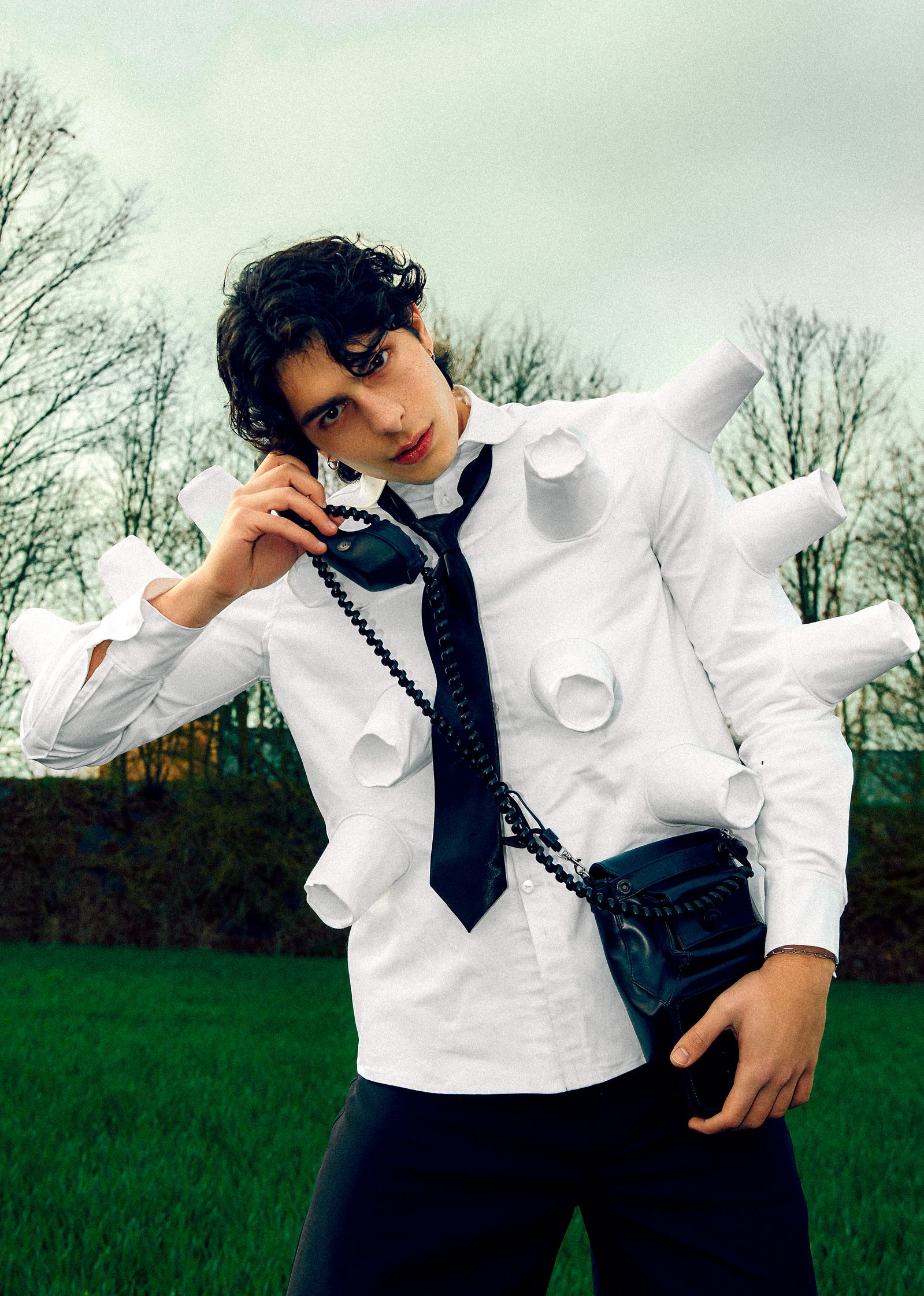 a man in a white shirt and tie talking on a cell phone