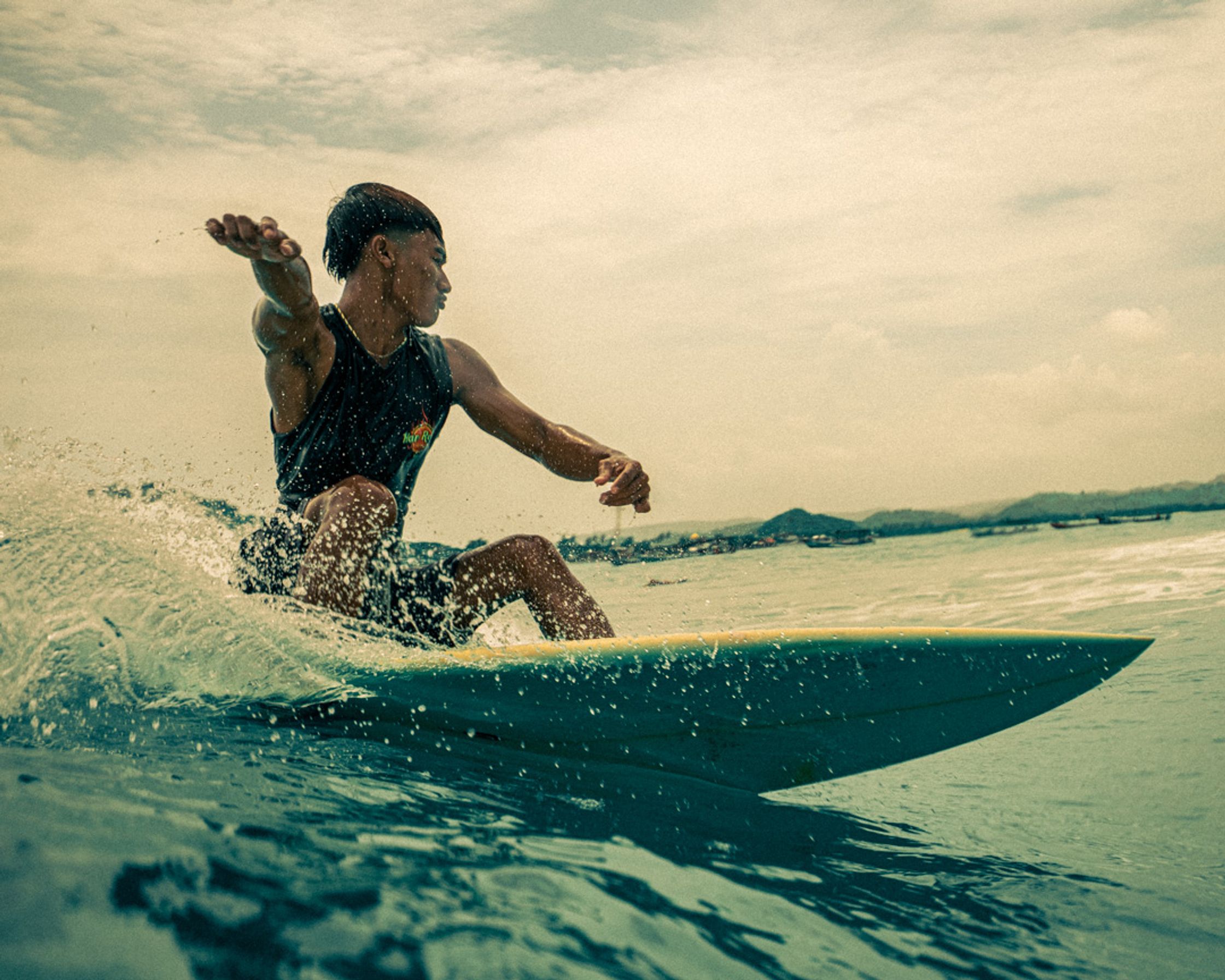 Action shot of a surfer carving a wave at Gerupuk reef, Lombok.