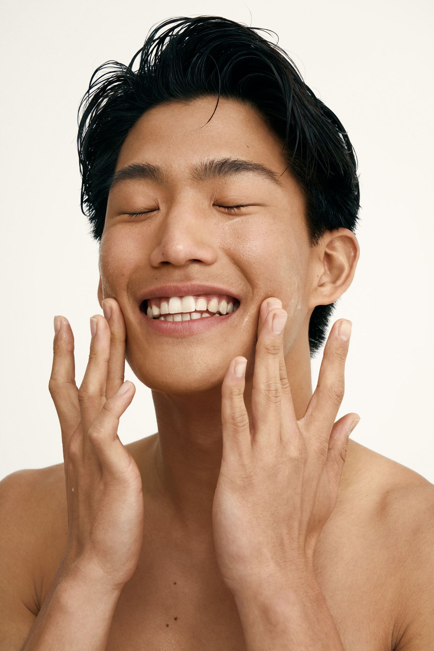 a man with his hands on his face