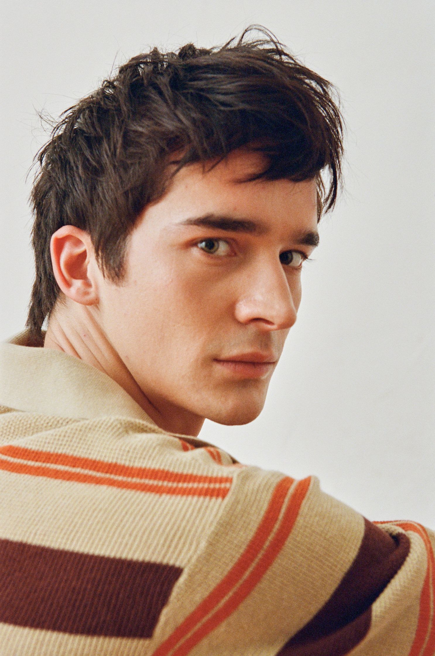 a man wearing a striped sweater