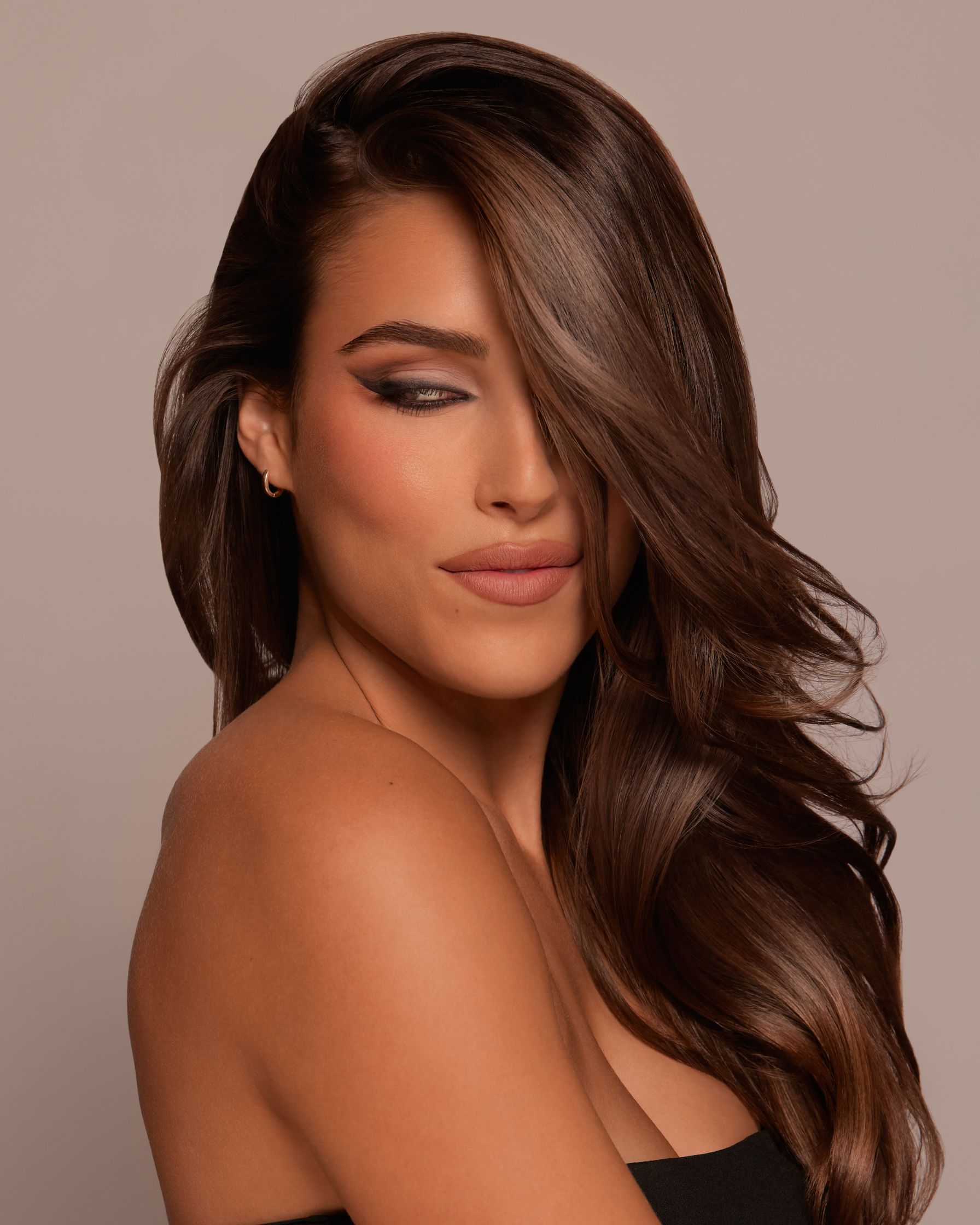 a woman with long brown hair posing for a photo