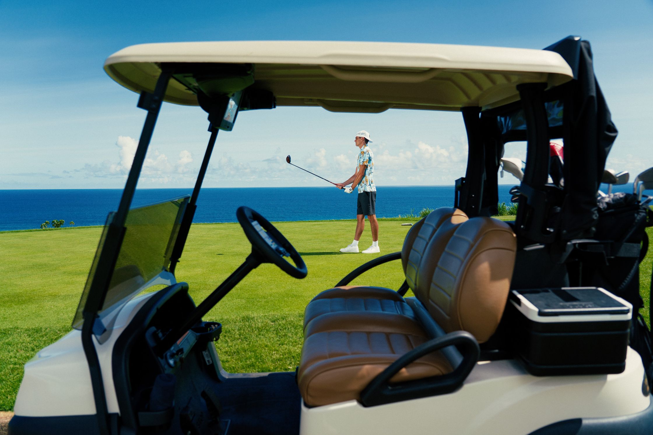 a golf cart with a man in the driver's seat